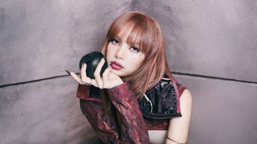 A detailed 5K portrait of Lisa from the K-pop group BLACKPINK, featuring her signature... wallpaper