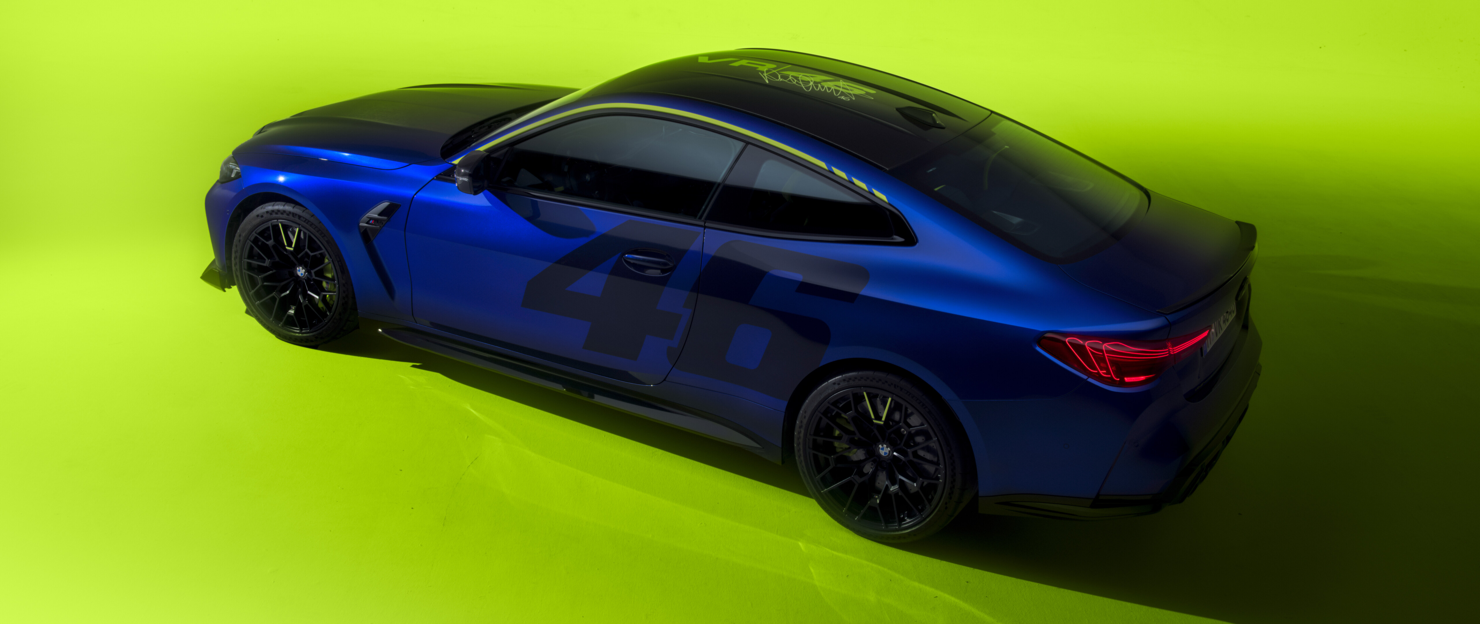 A sleek BMW M4 CS Edition featuring the yellow and black VR46 Valentino Rossi racing livery and decals.