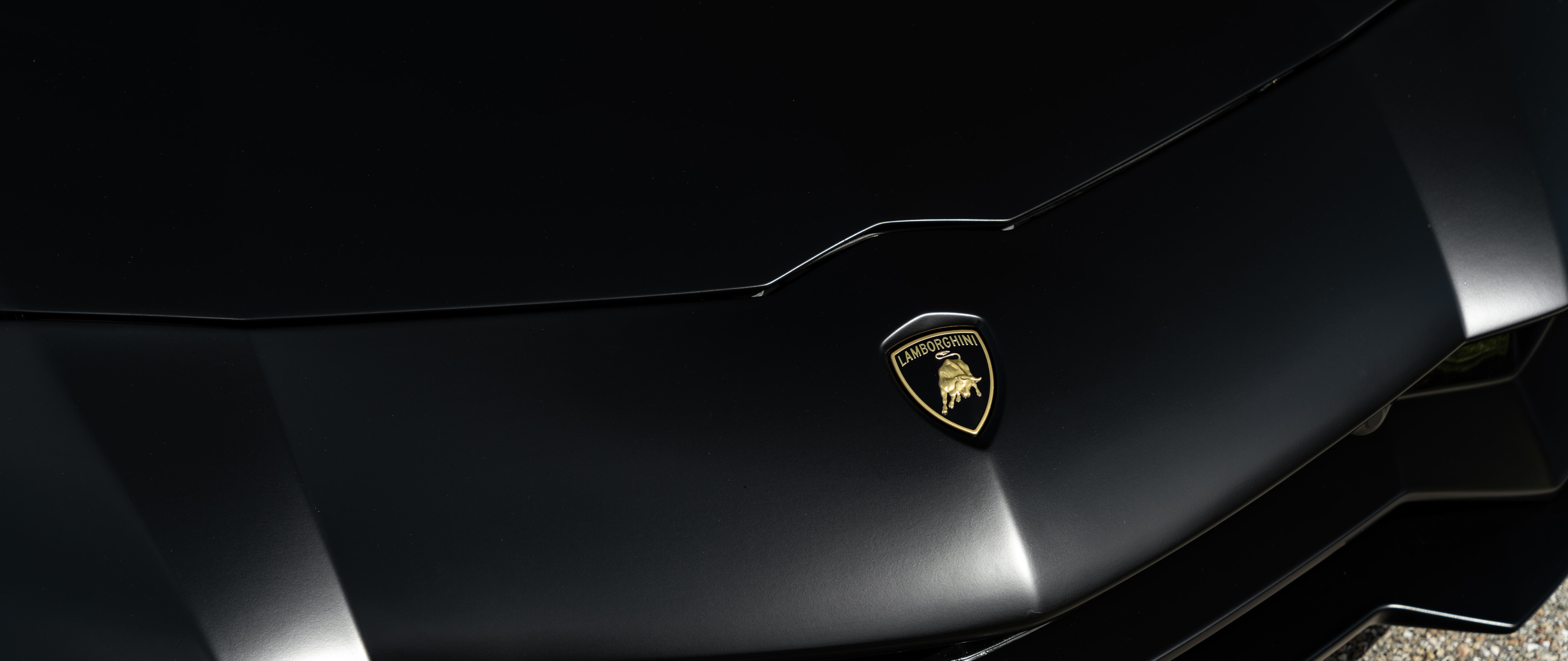 A sleek and aerodynamic Lamborghini supercar featuring a polished-metallic exterior and aggressive styling.
