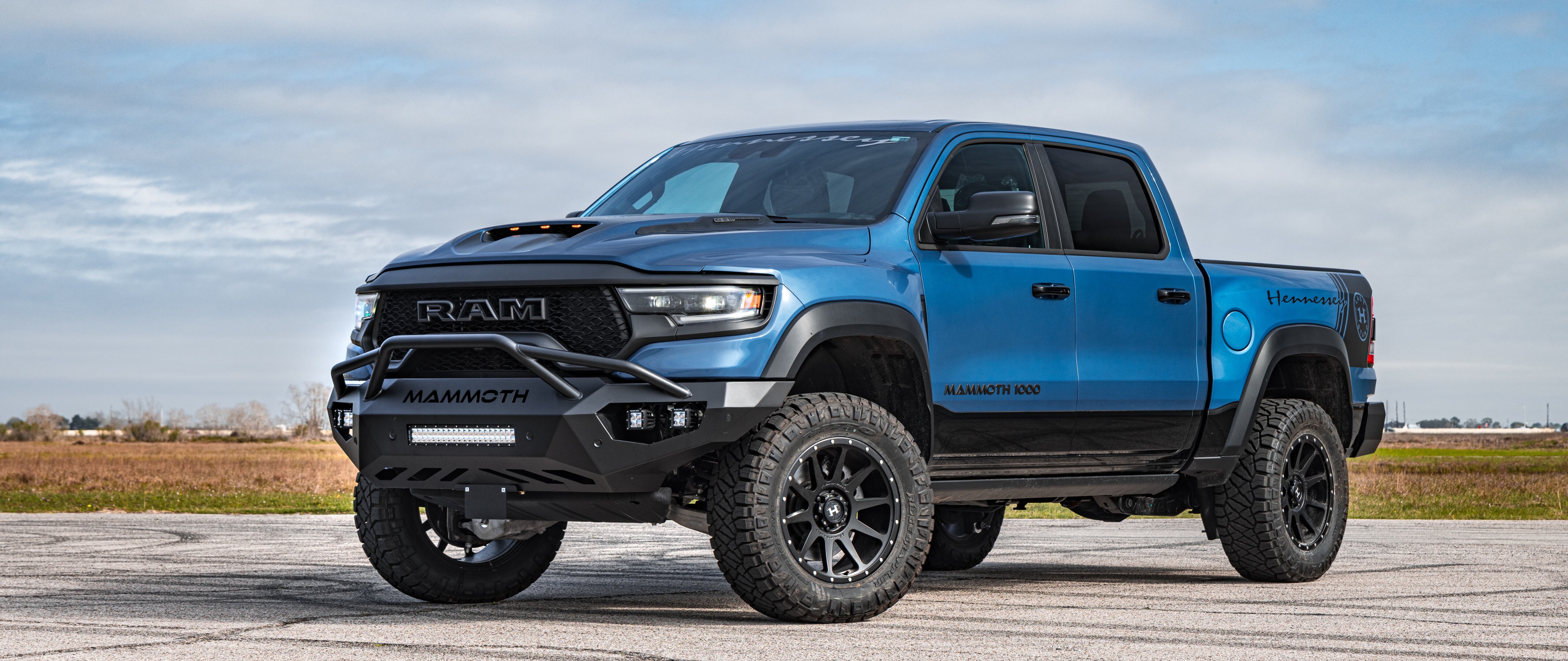 A massive, lifted Hennessey Mammoth 1000 Dodge Ram truck with aggressive off-road modifications and wide-body styling.