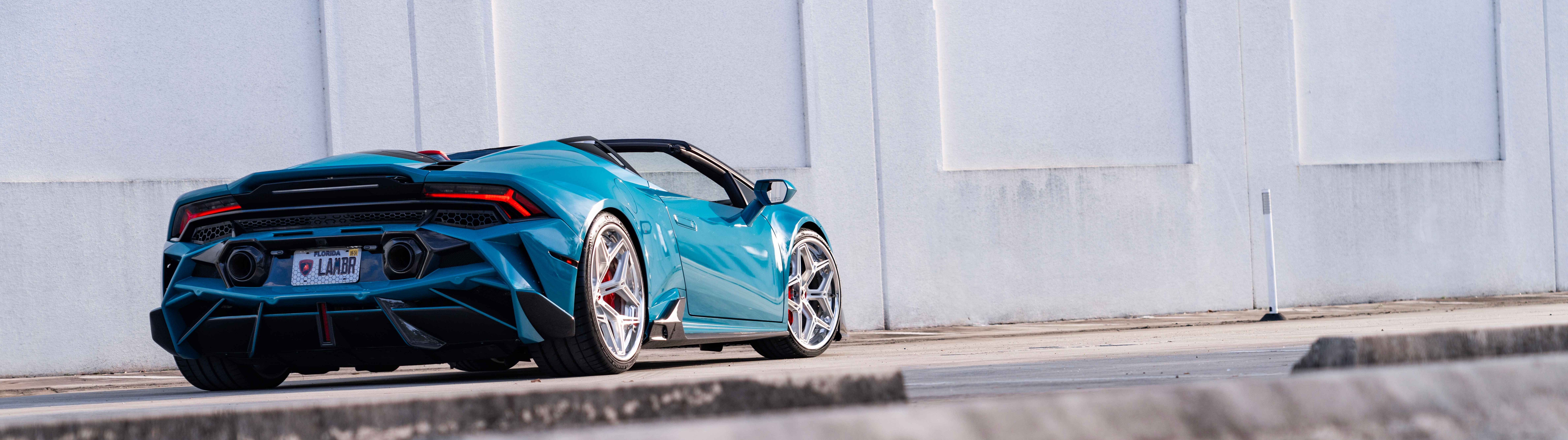 A detailed view of a Lamborghini Huracan Evo featuring its iconic aerodynamic body and sleek supercar silhouette.