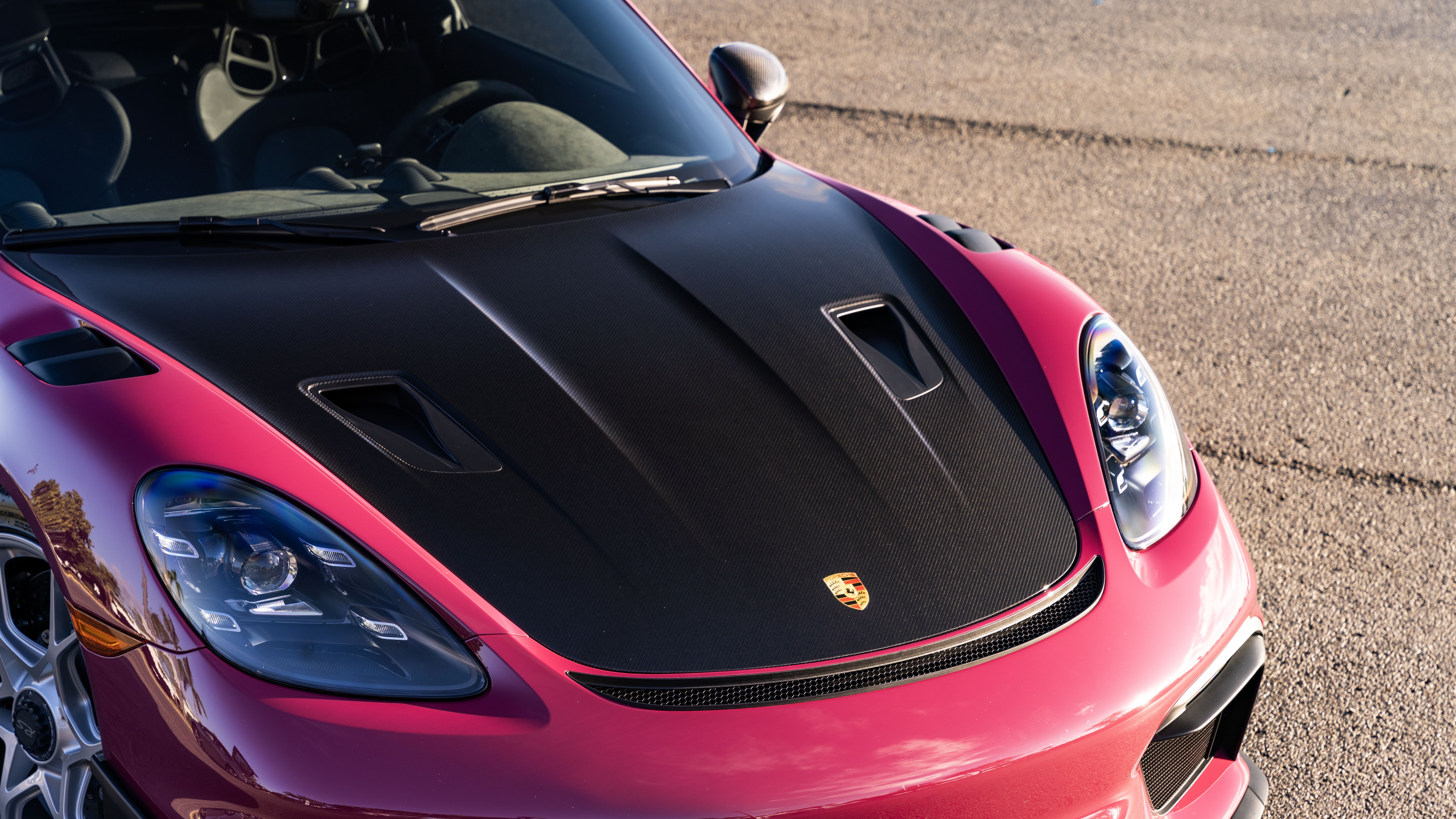 A high-detail shot of a sleek Porsche sports car reflecting light.