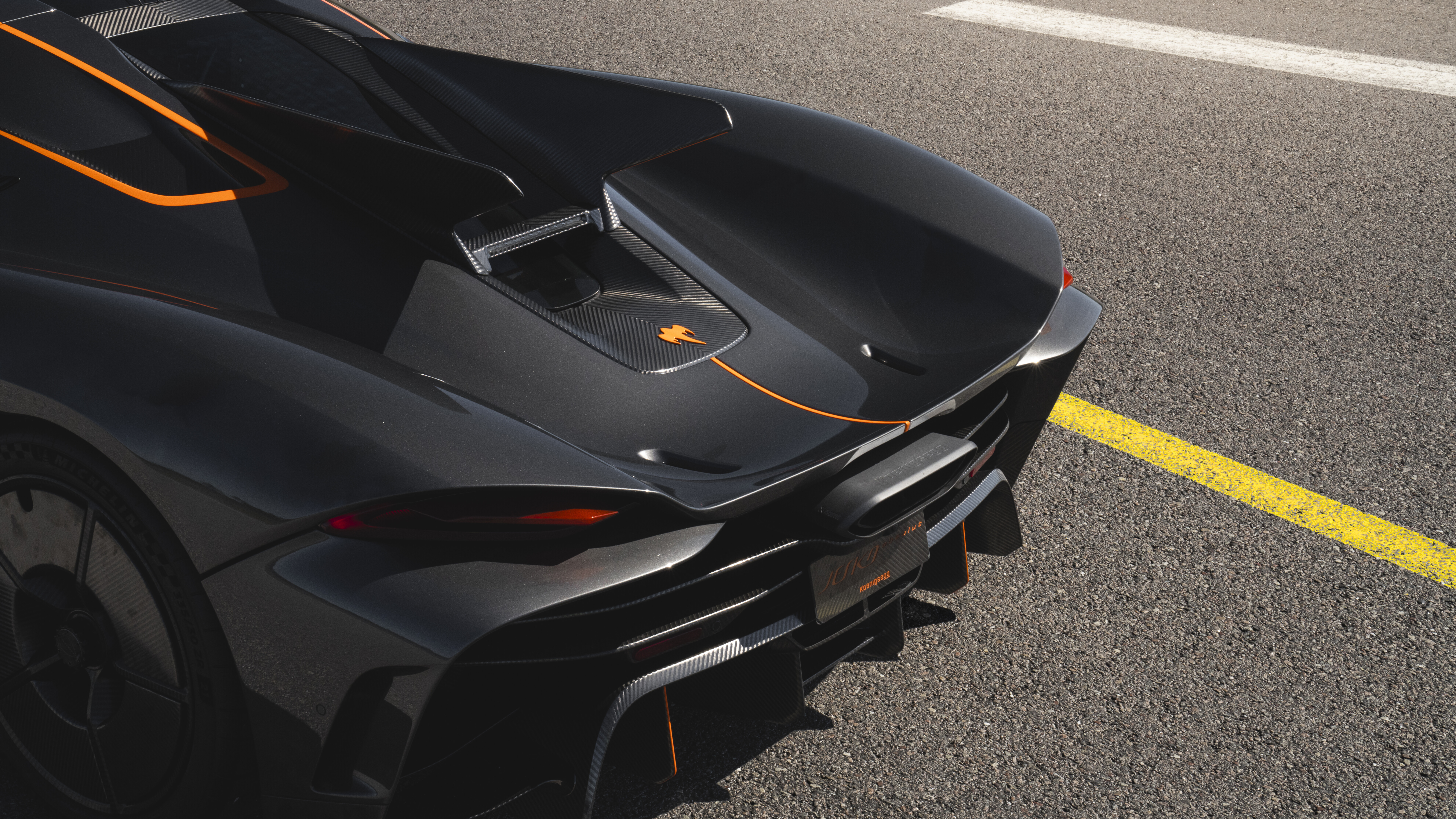 A sleek and aerodynamic Koenigsegg Jesko Absolut hypercar in a high-performance setting.