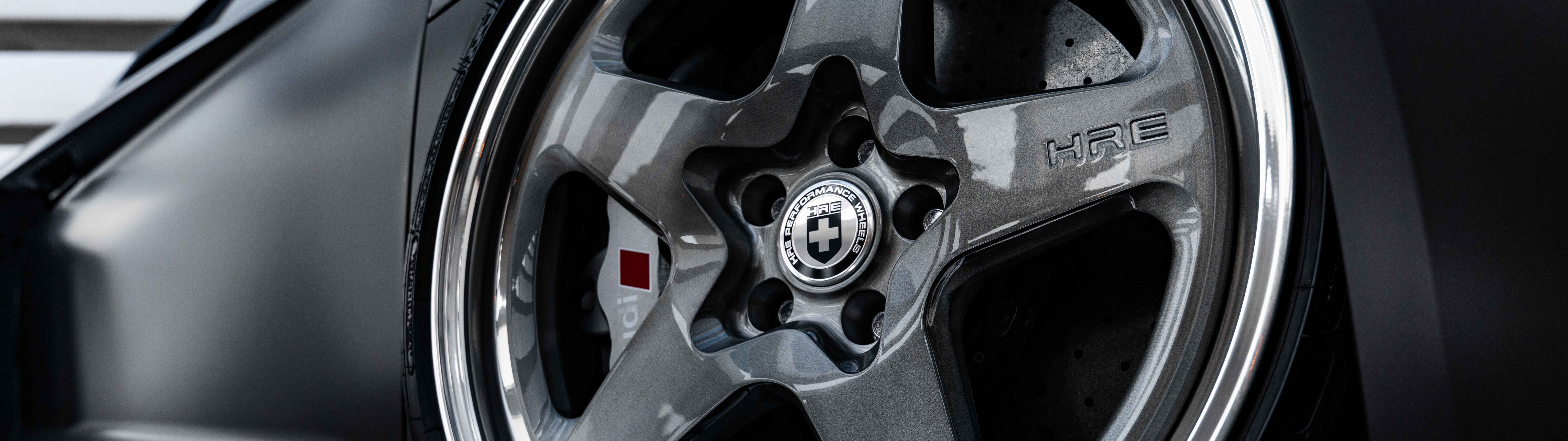 A professional close-up shot of a sleek Audi luxury sedan featuring a polished metallic finish.