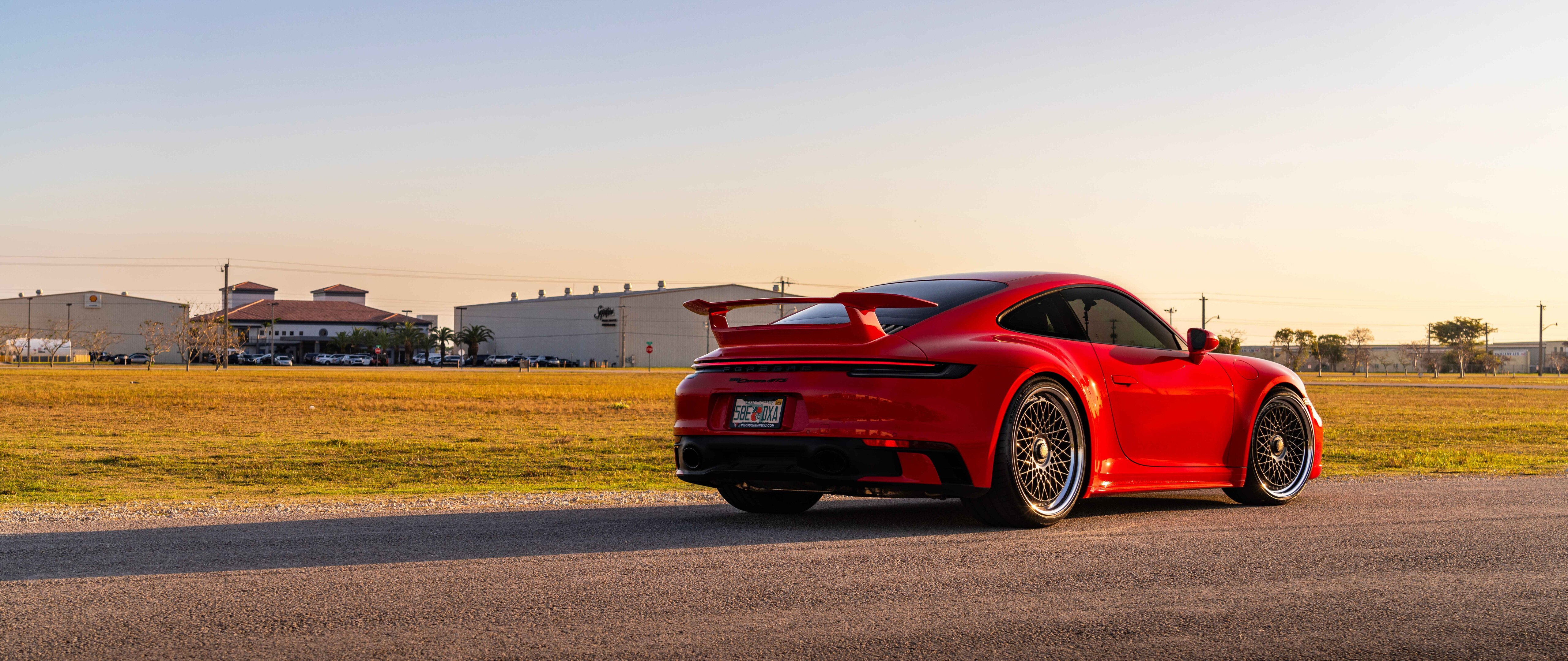 A high-resolution, close-up shot of a sleek Porsche 992 GTS sports car featuring its iconic aerodynamic body and premium finish.