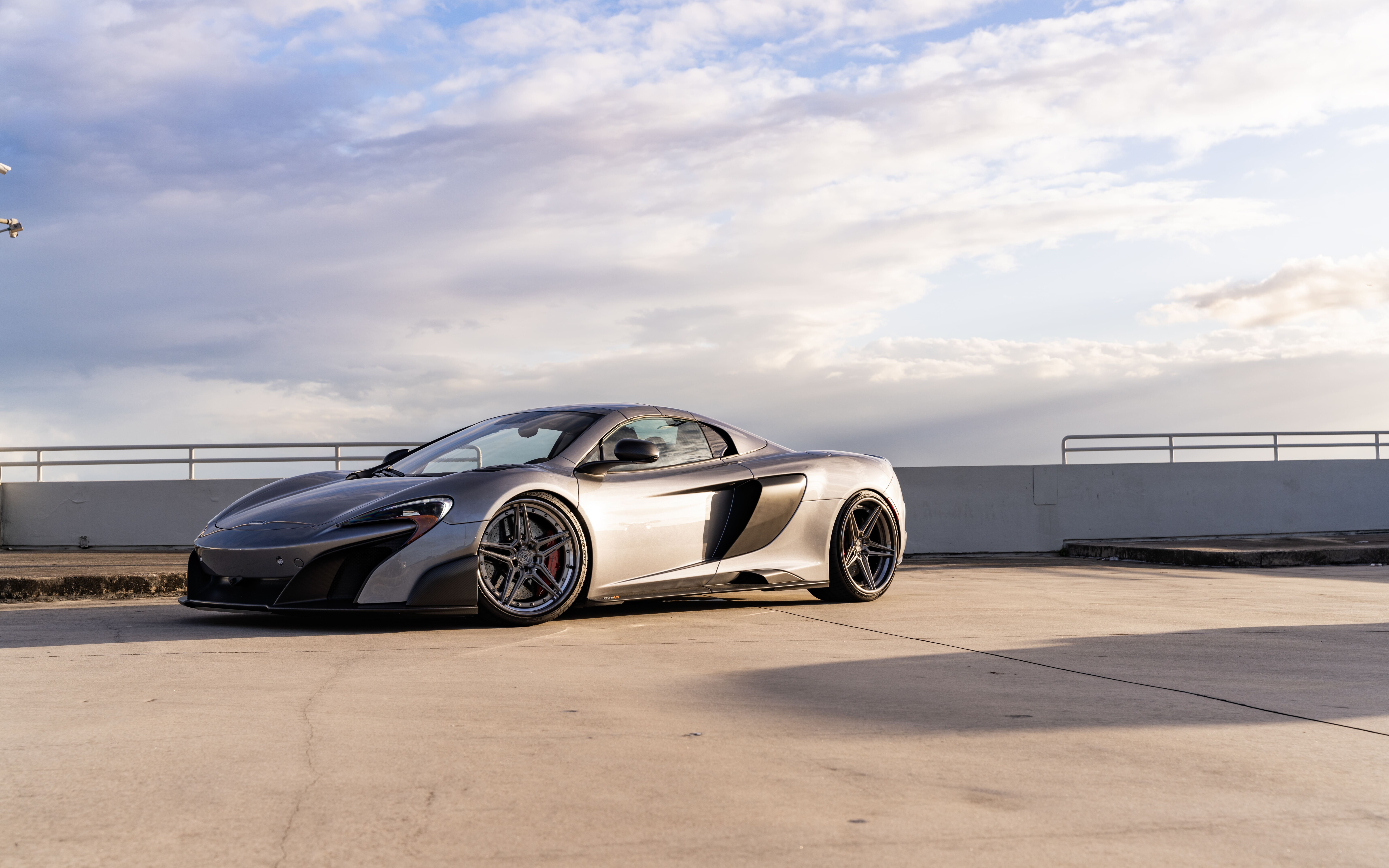 A high-performance McLaren supercar featuring sleek aerodynamic lines and a polished metallic finish.
