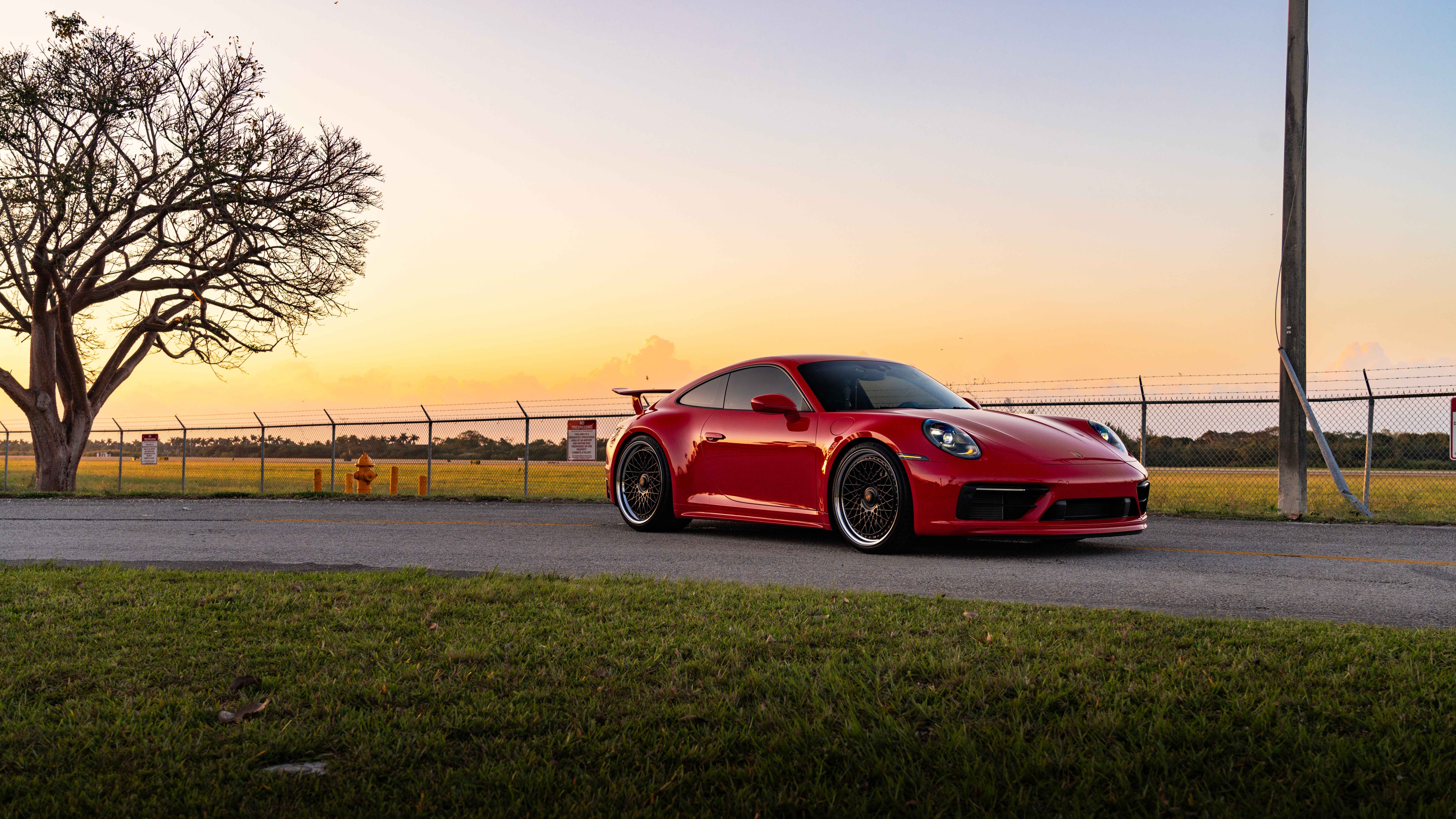 Close-up shot of a Porsche 992 GTS sports car featuring its iconic silhouette and sleek metallic finish.