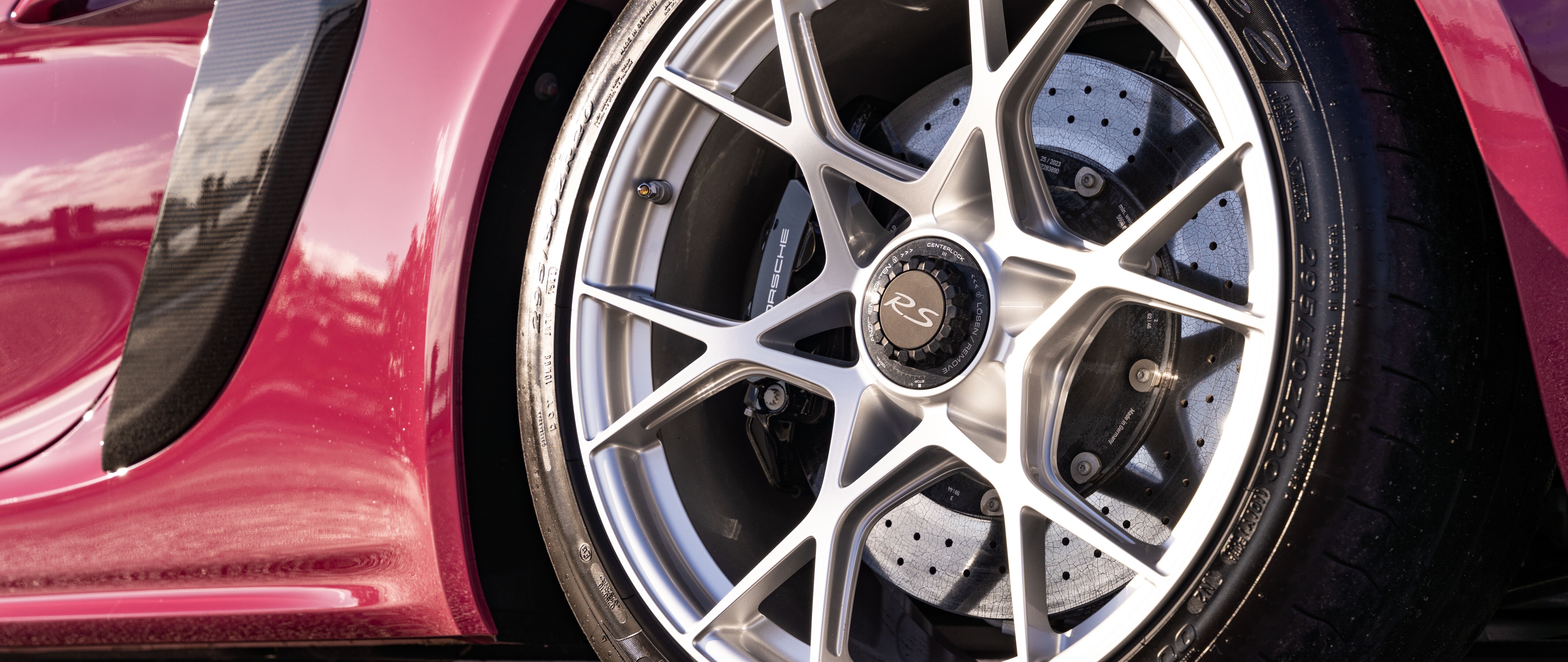 A sleek, high-performance Porsche sports car captured in a stunning light.