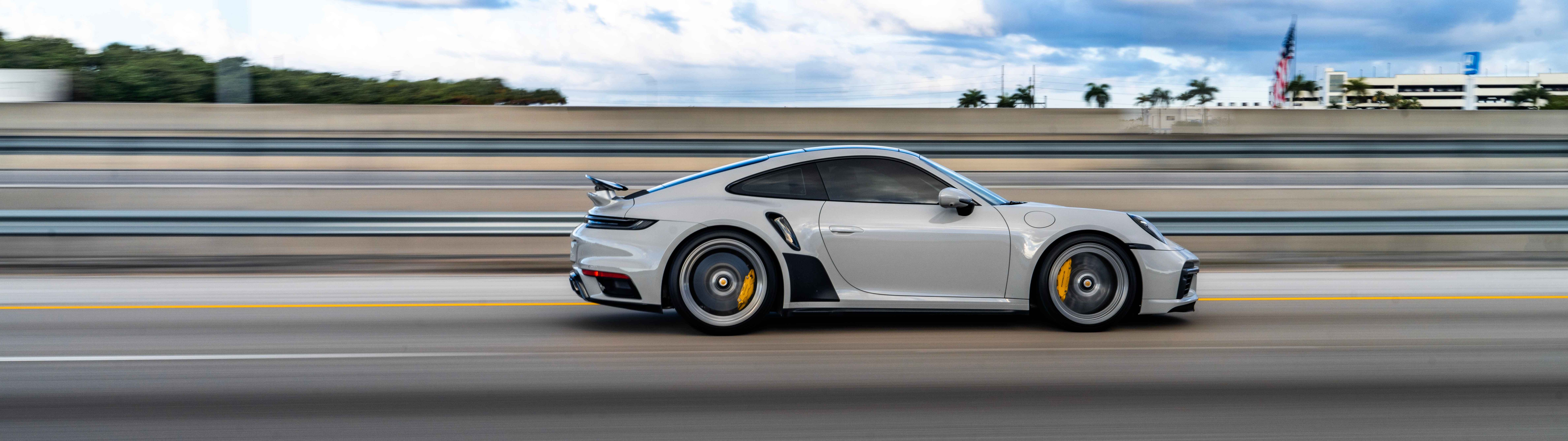 A close-up view of a luxury Porsche sports car featuring a sleek design and metallic finish.