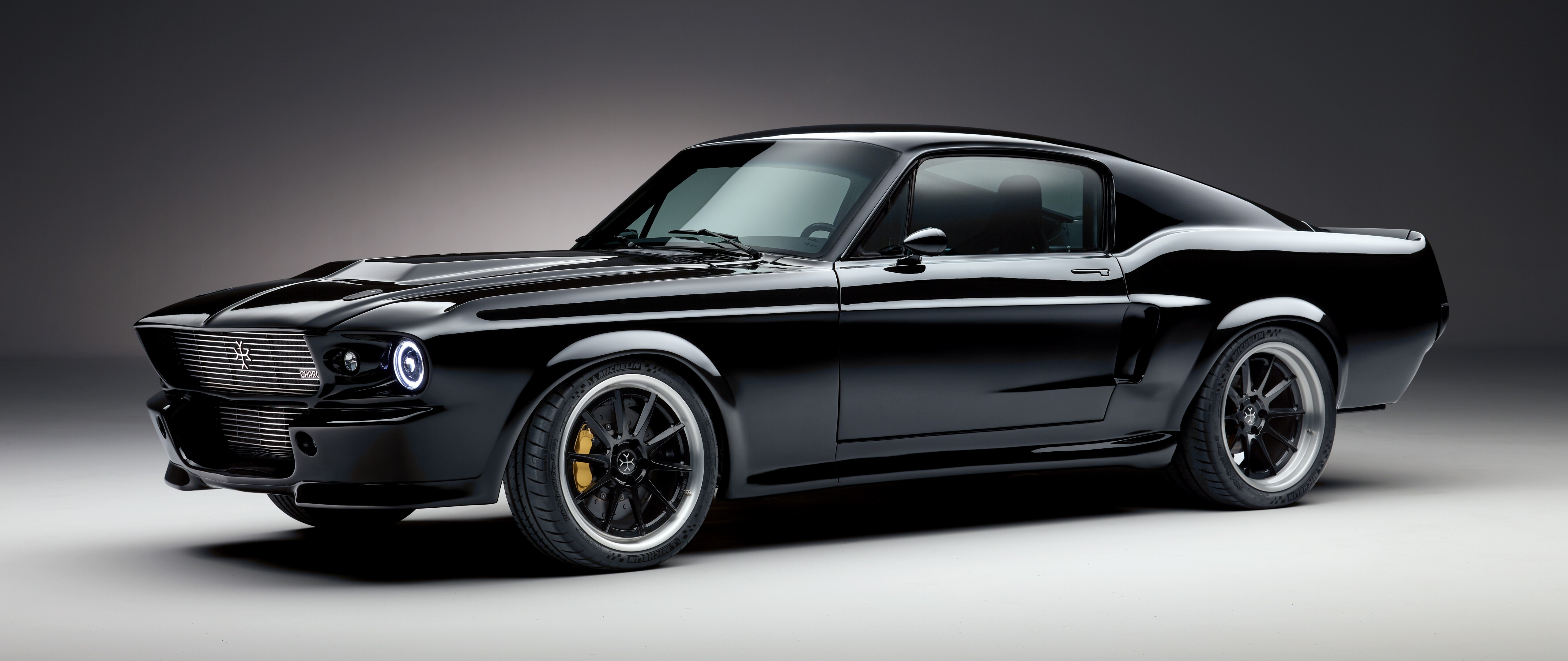 A modern black electric Ford Mustang muscle car with a sleek, aggressive design.