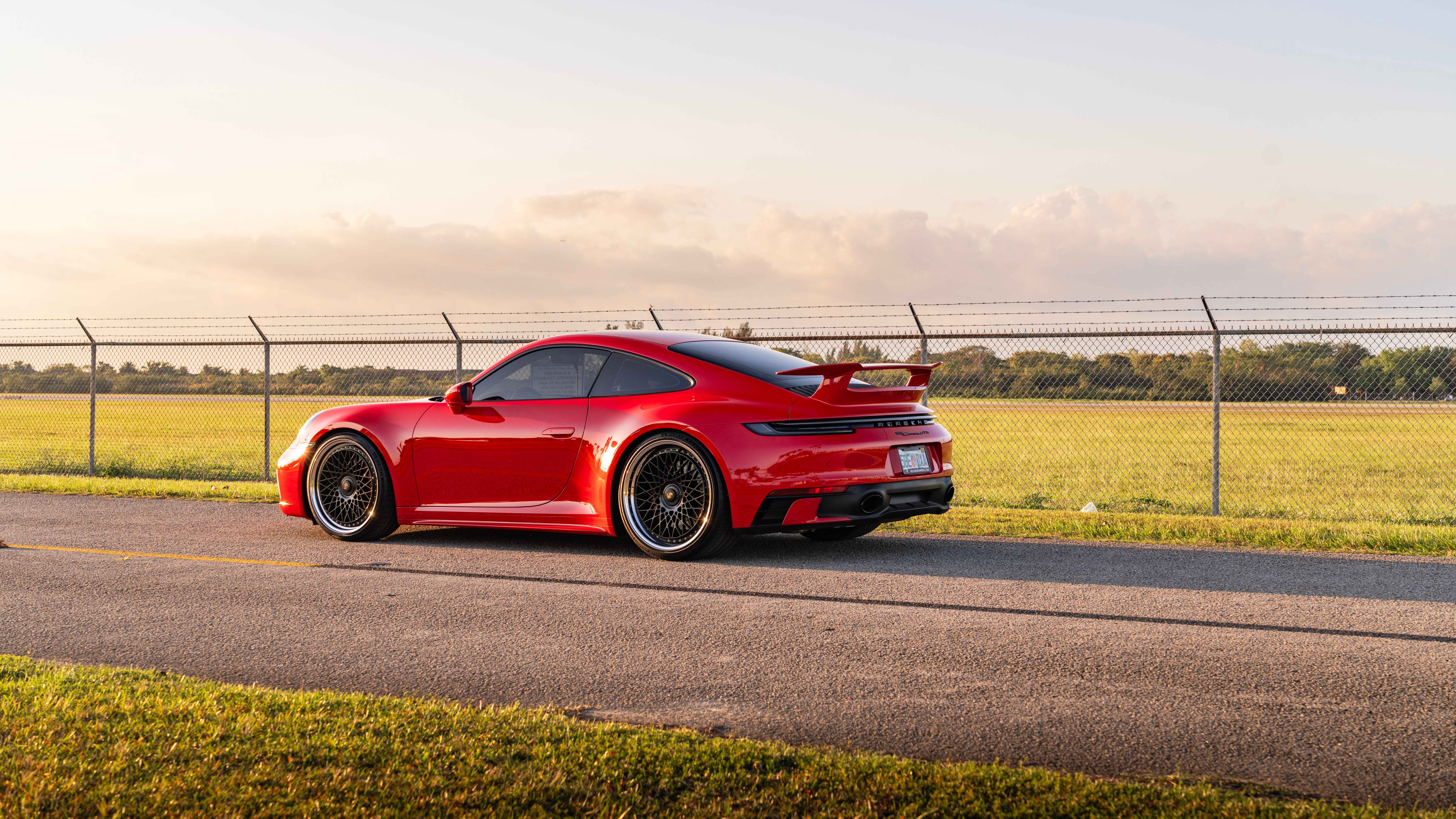 A professional photograph of a Porsche 992 GTS sports car.