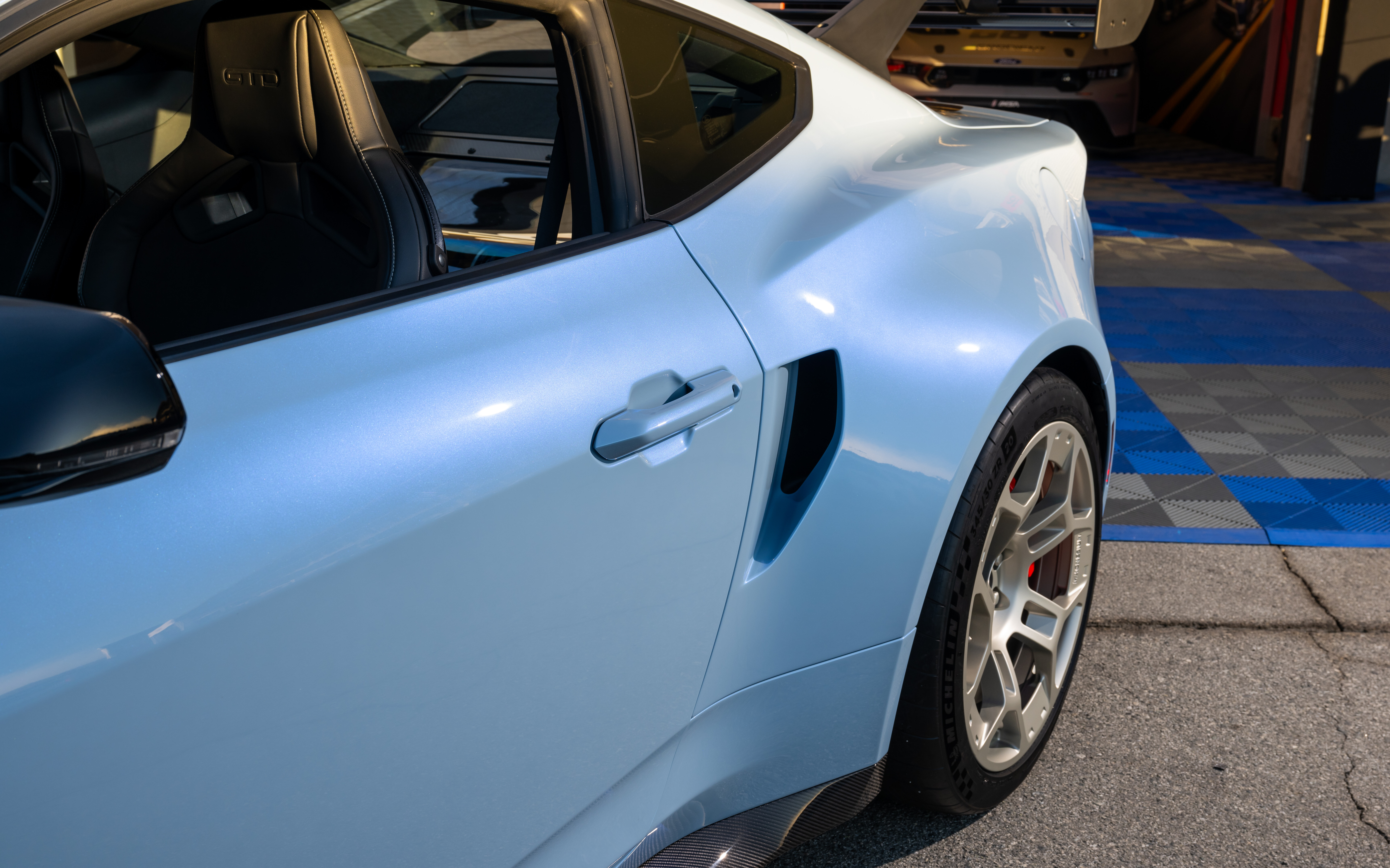 A detailed view of a Ford Mustang GTD featuring its aggressive aerodynamic styling and wide-body kit.