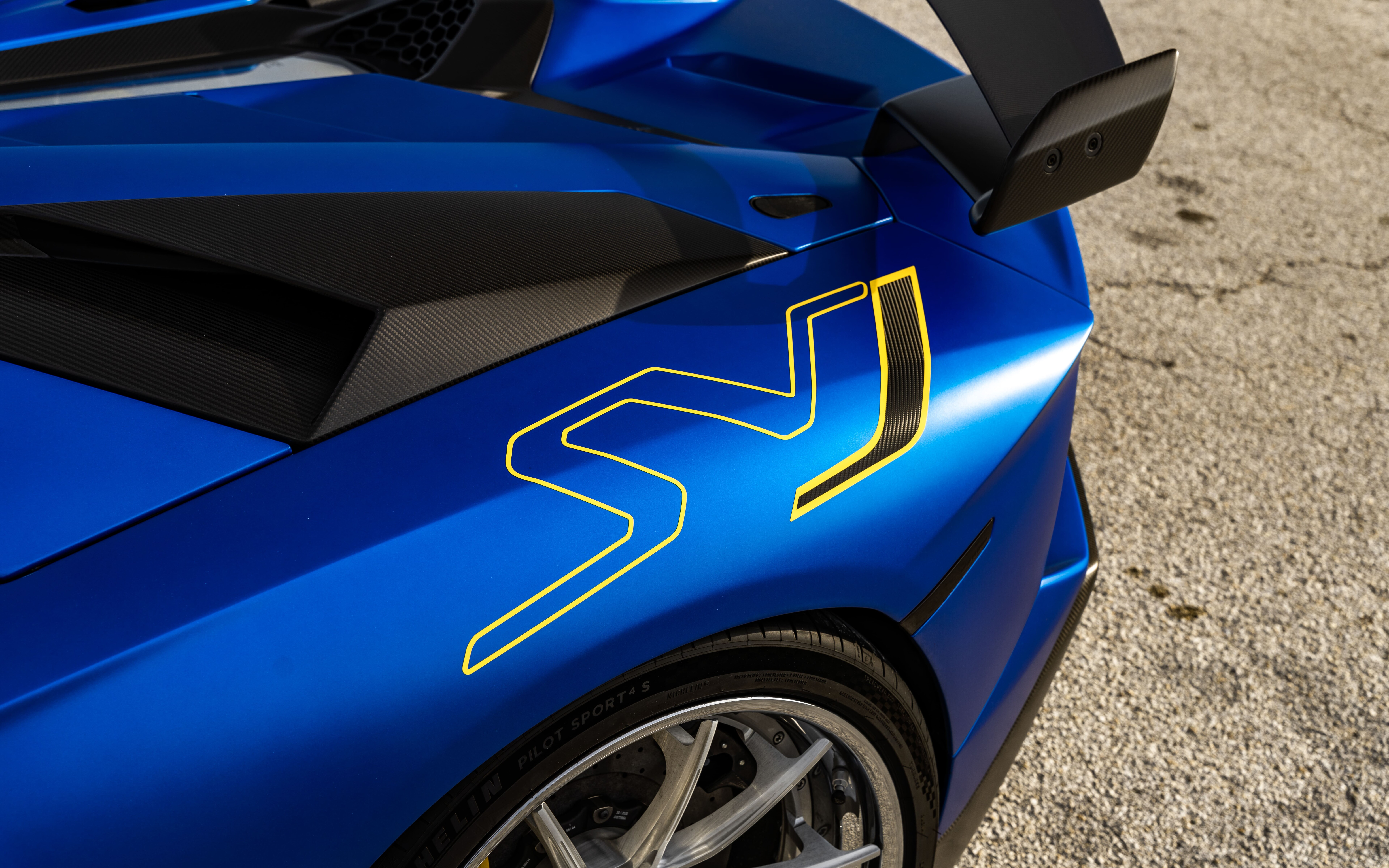 A sleek and powerful Lamborghini Aventador SVJ featuring its signature aerodynamic body and aggressive front fascia.