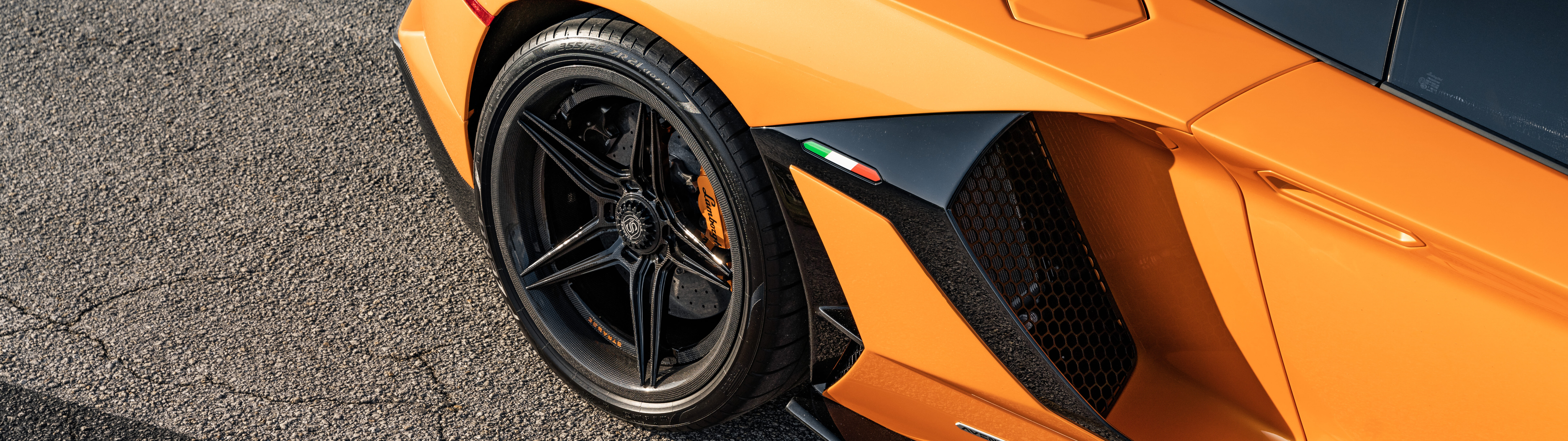 A high-performance Lamborghini Aventador SVJ showcasing its sleek aerodynamic design and luxury finish.