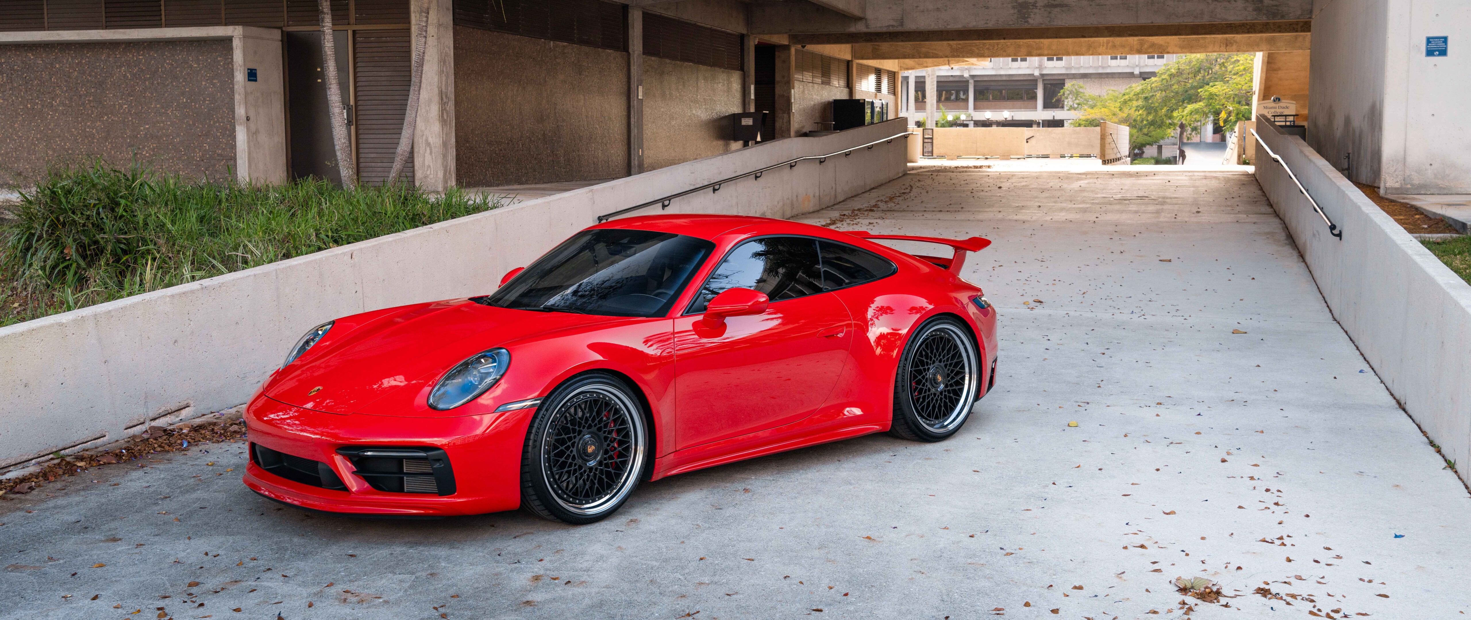 A detailed view of a Porsche 992 GTS sports car highlighting its aerodynamic body and aggressive styling.