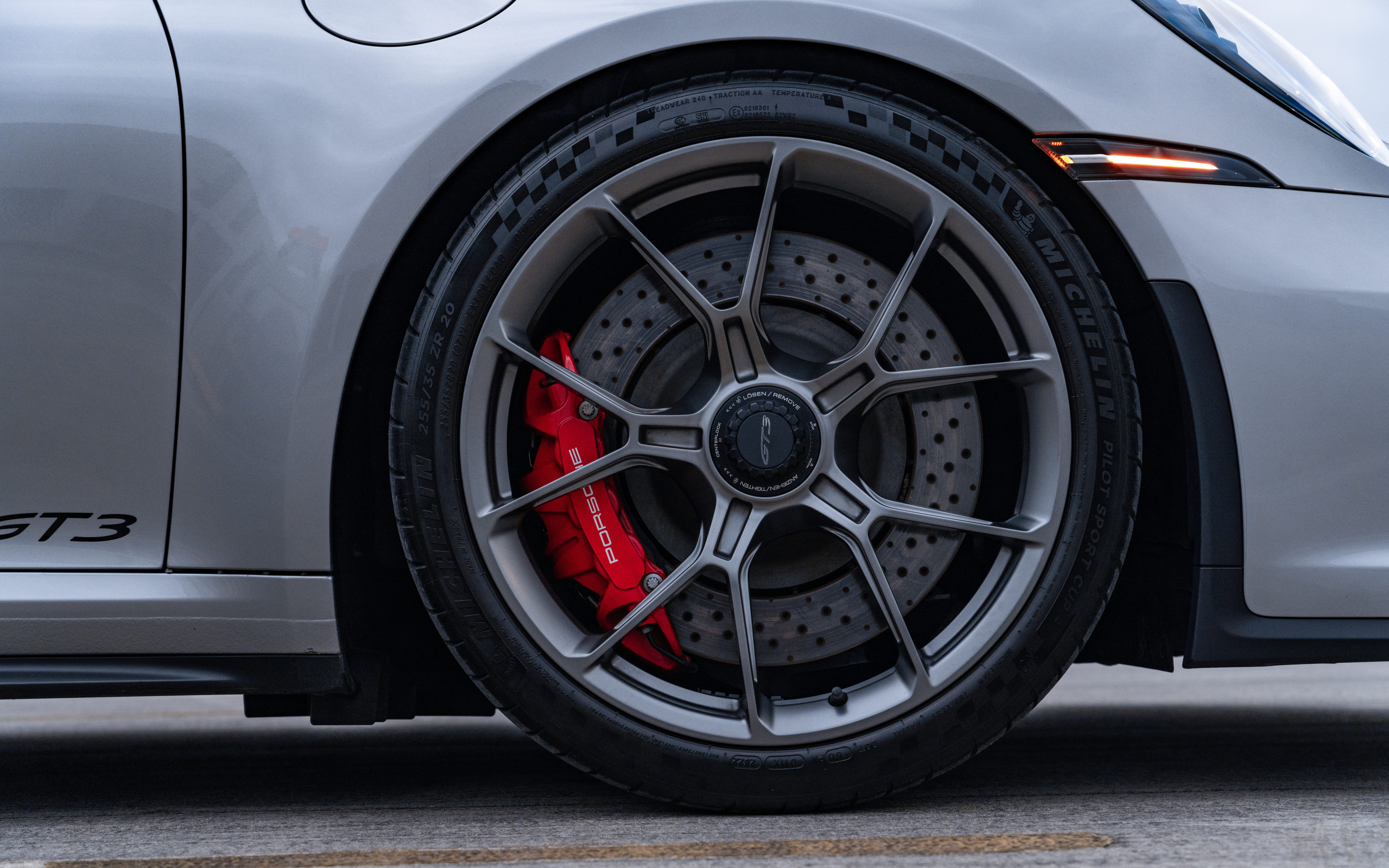 A high-performance Porsche GT3 RS sports car featuring aerodynamic bodywork and a signature rear spoiler.