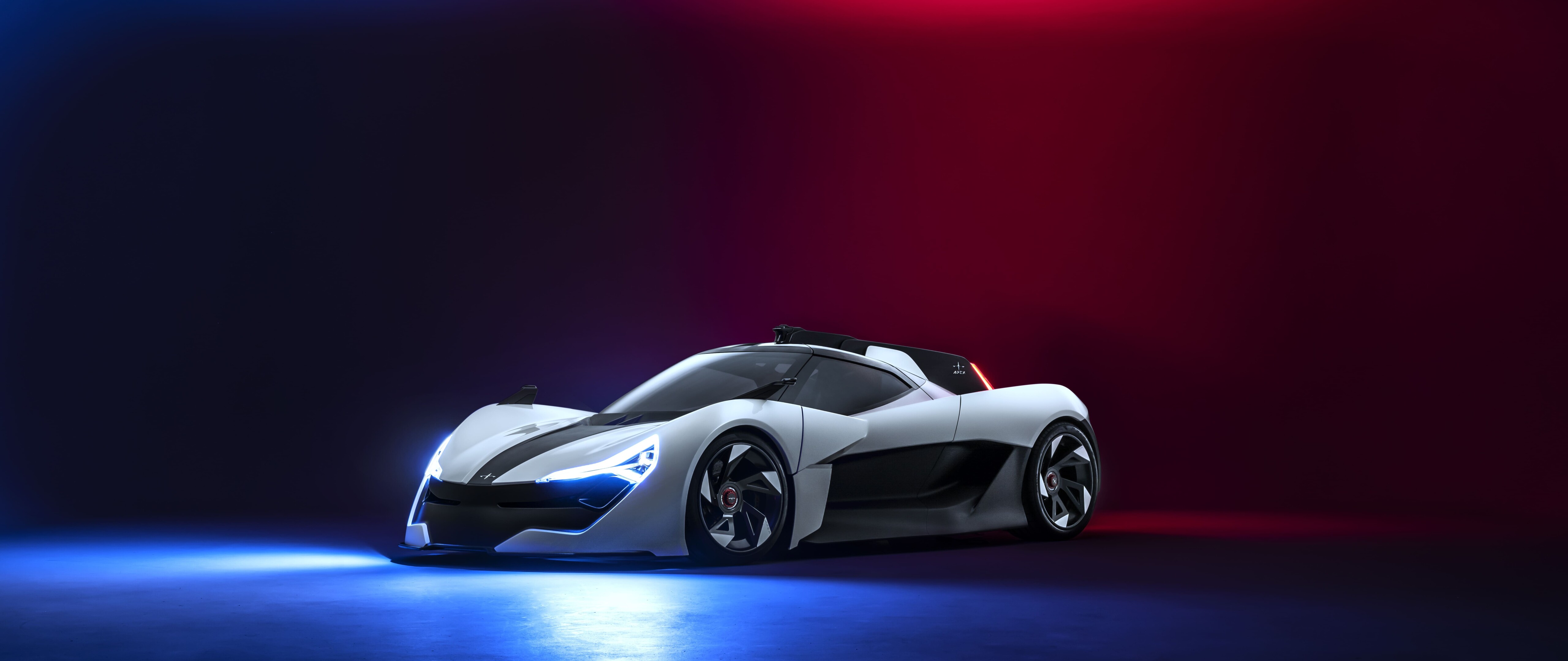 A sleek, aerodynamic modern sports car presented in a professional studio setting.