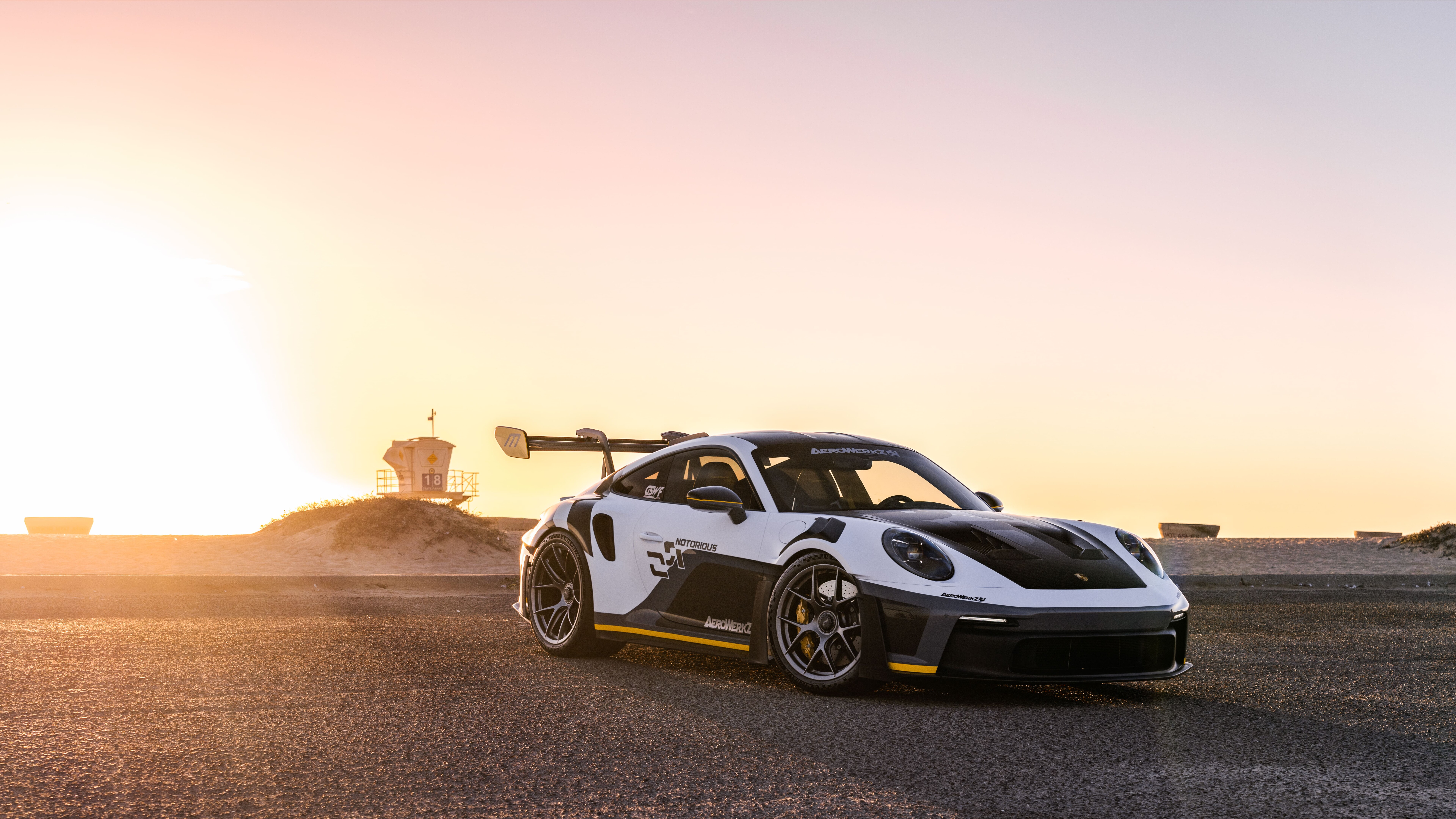 A high-performance Porsche GT3 RS sports car featuring aggressive aerodynamic bodywork and a large rear spoiler.