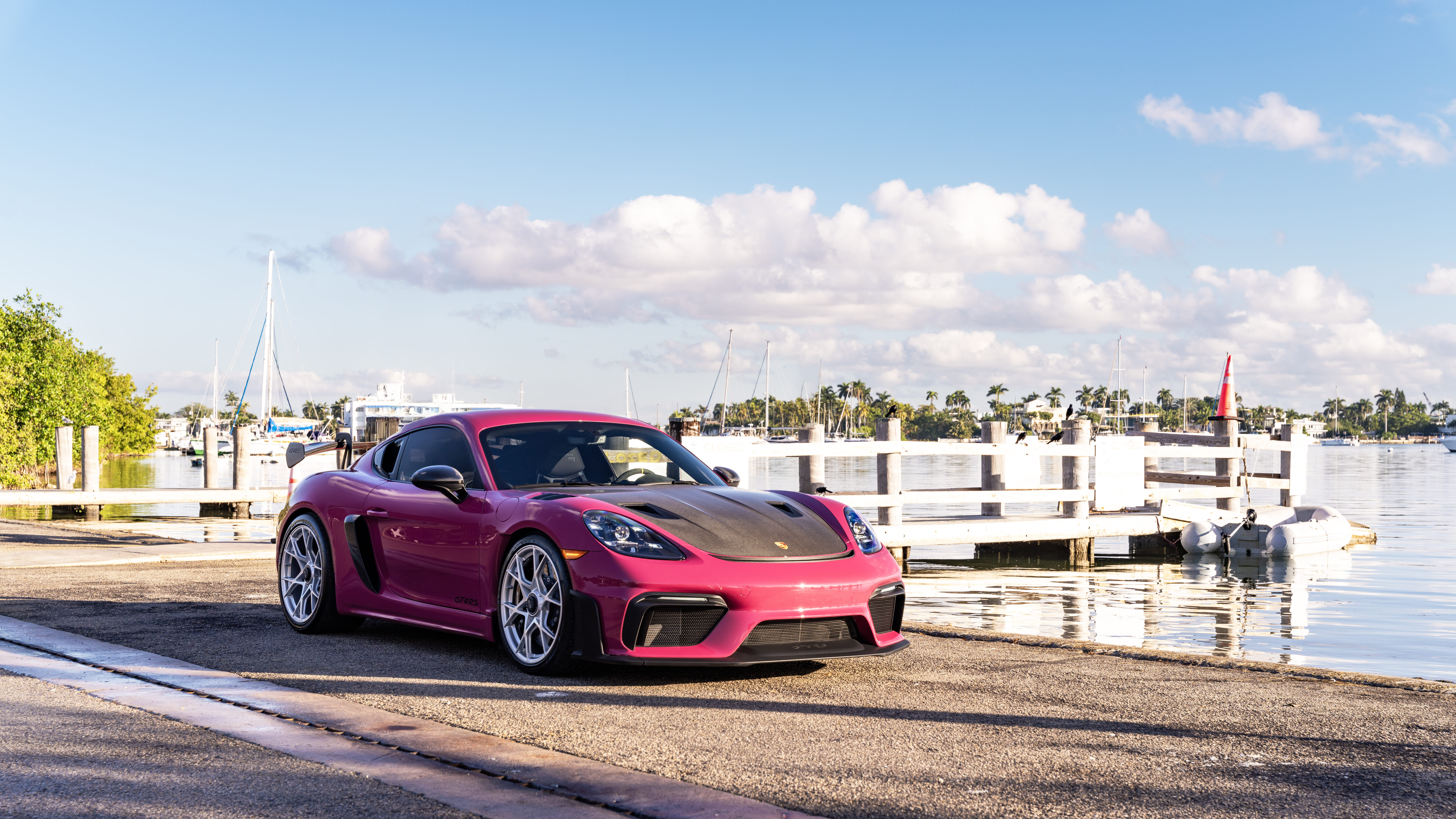 A luxury Porsche sports car parked on a modern urban street during twilight.