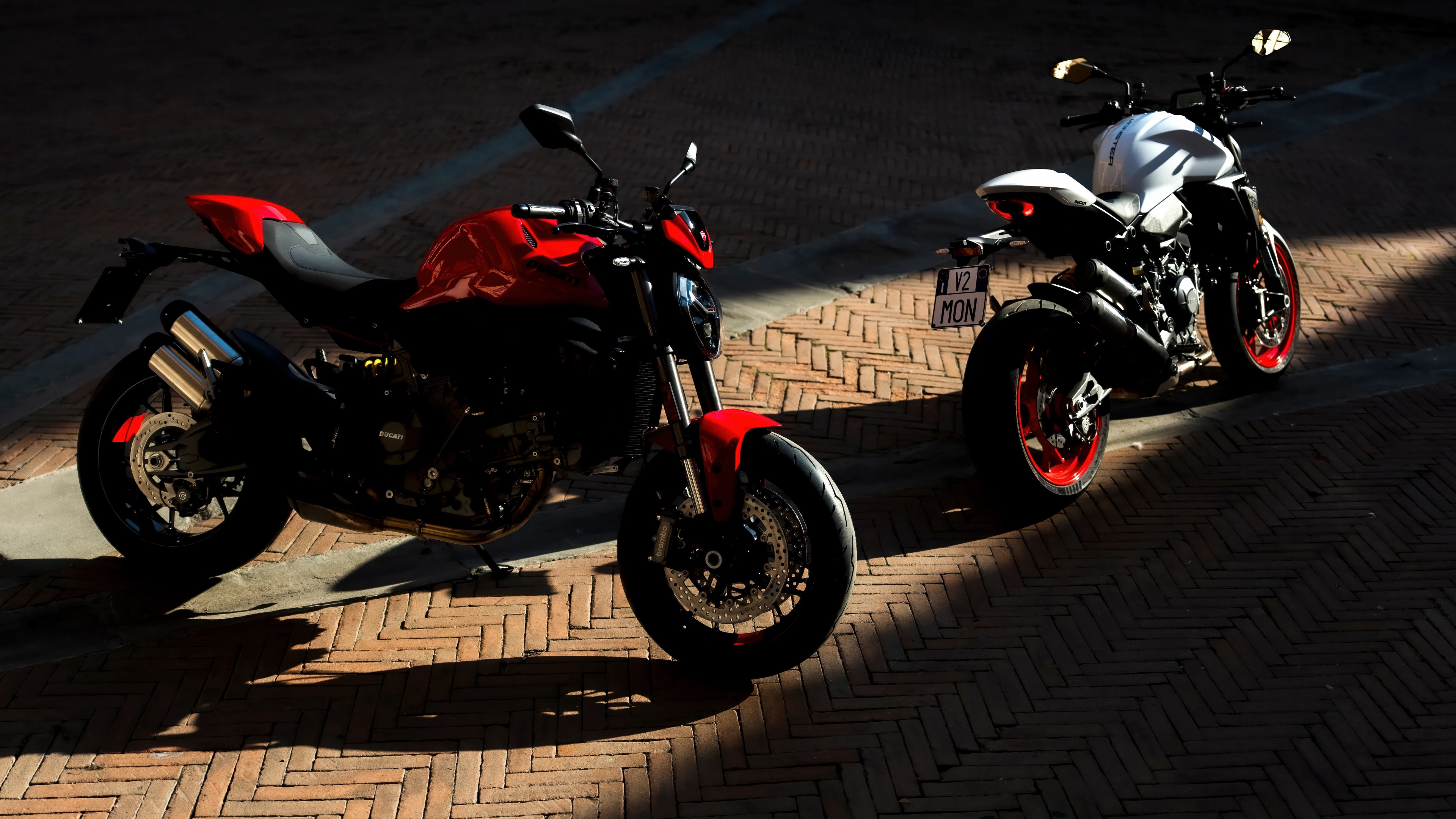 A futuristic and sleek 2026 Ducati Monster V2 sports motorcycle in high resolution.