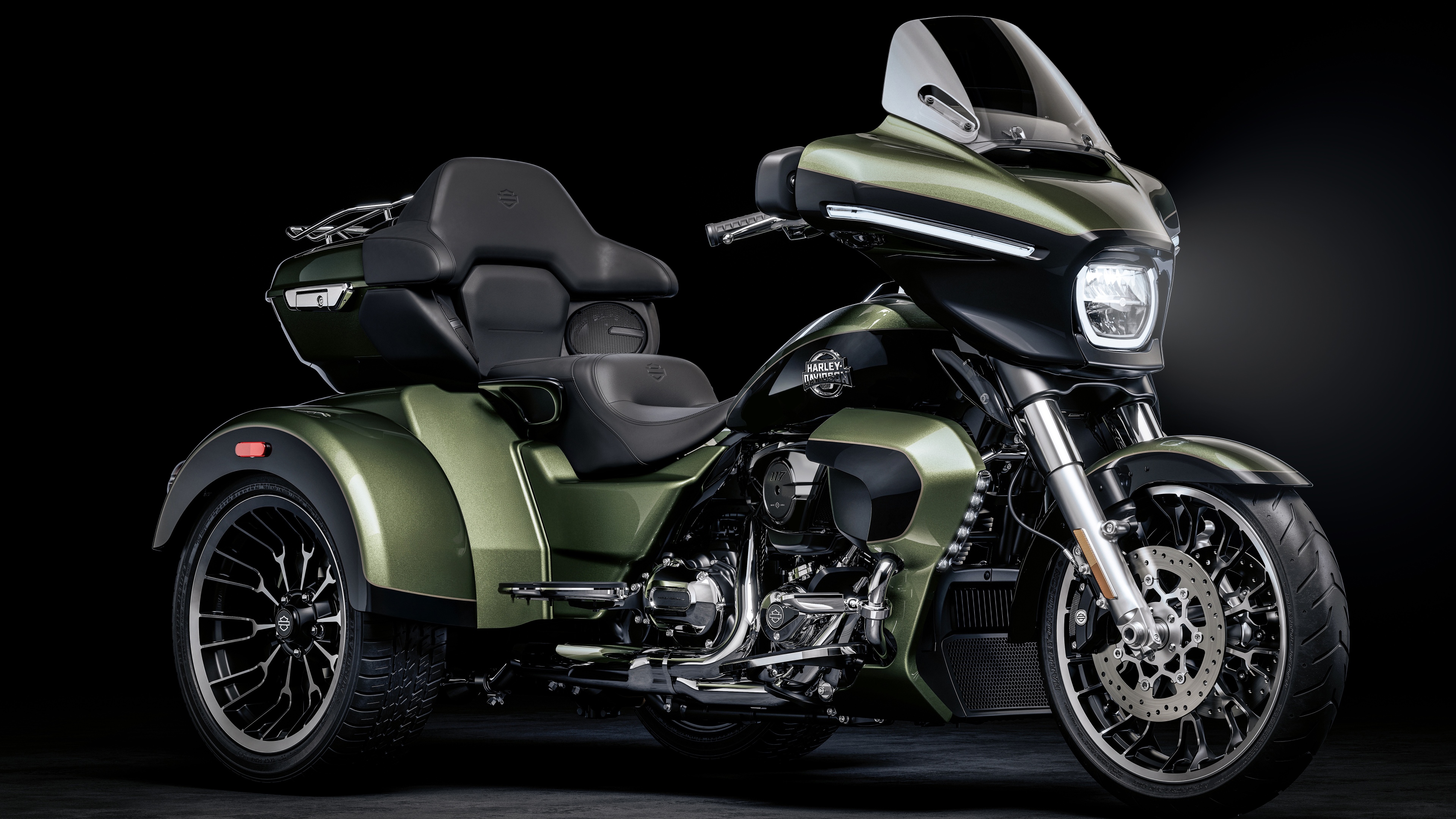 A cinematic, high-detail shot of a Harley-Davidson Street Glide cruiser motorcycle against a dark, atmospheric background.
