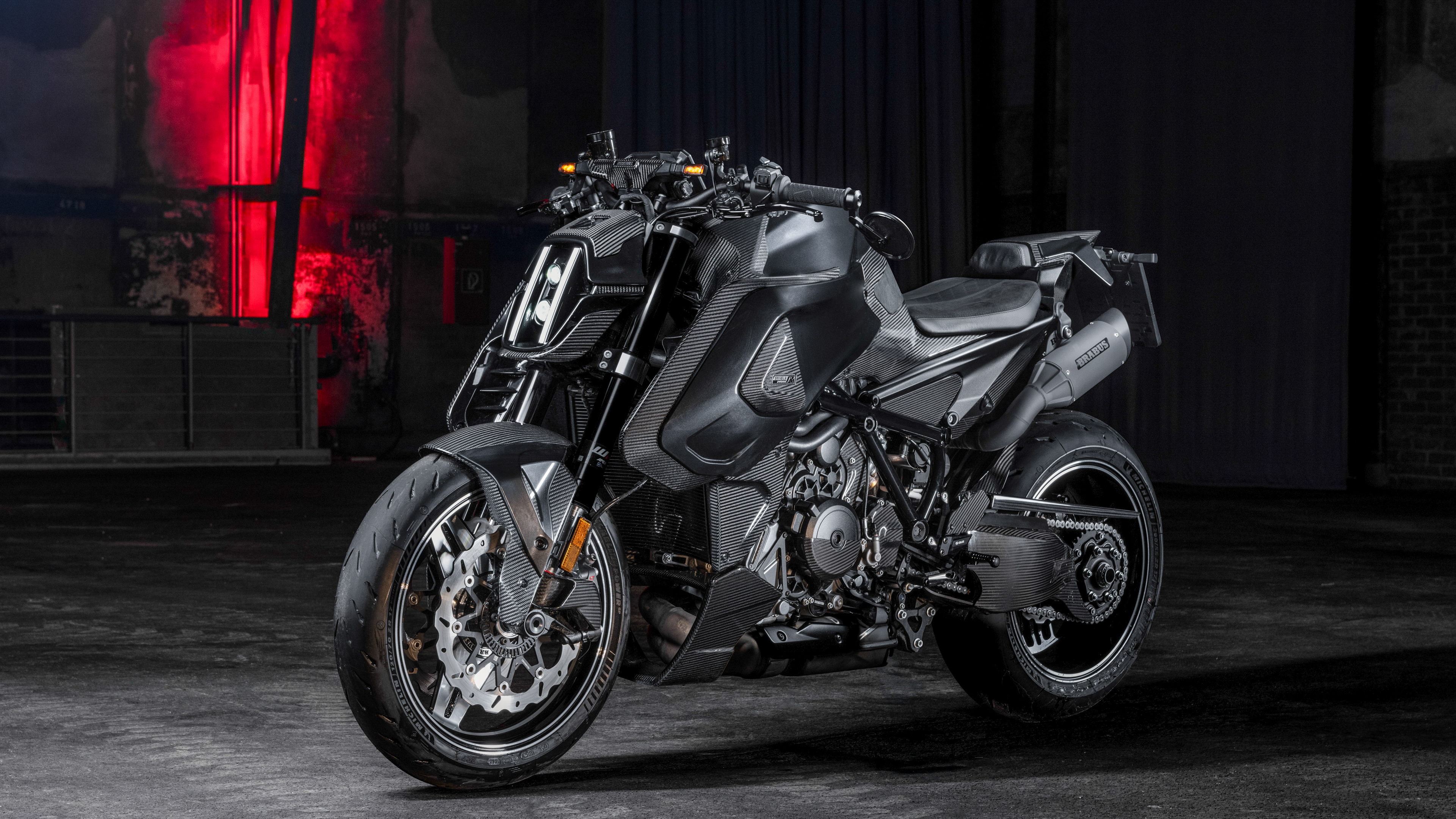 A close-up of a dark, futuristic Brabus 1400 R Signature Edition motorcycle featuring carbon fiber accents and a luxury naked bike design.