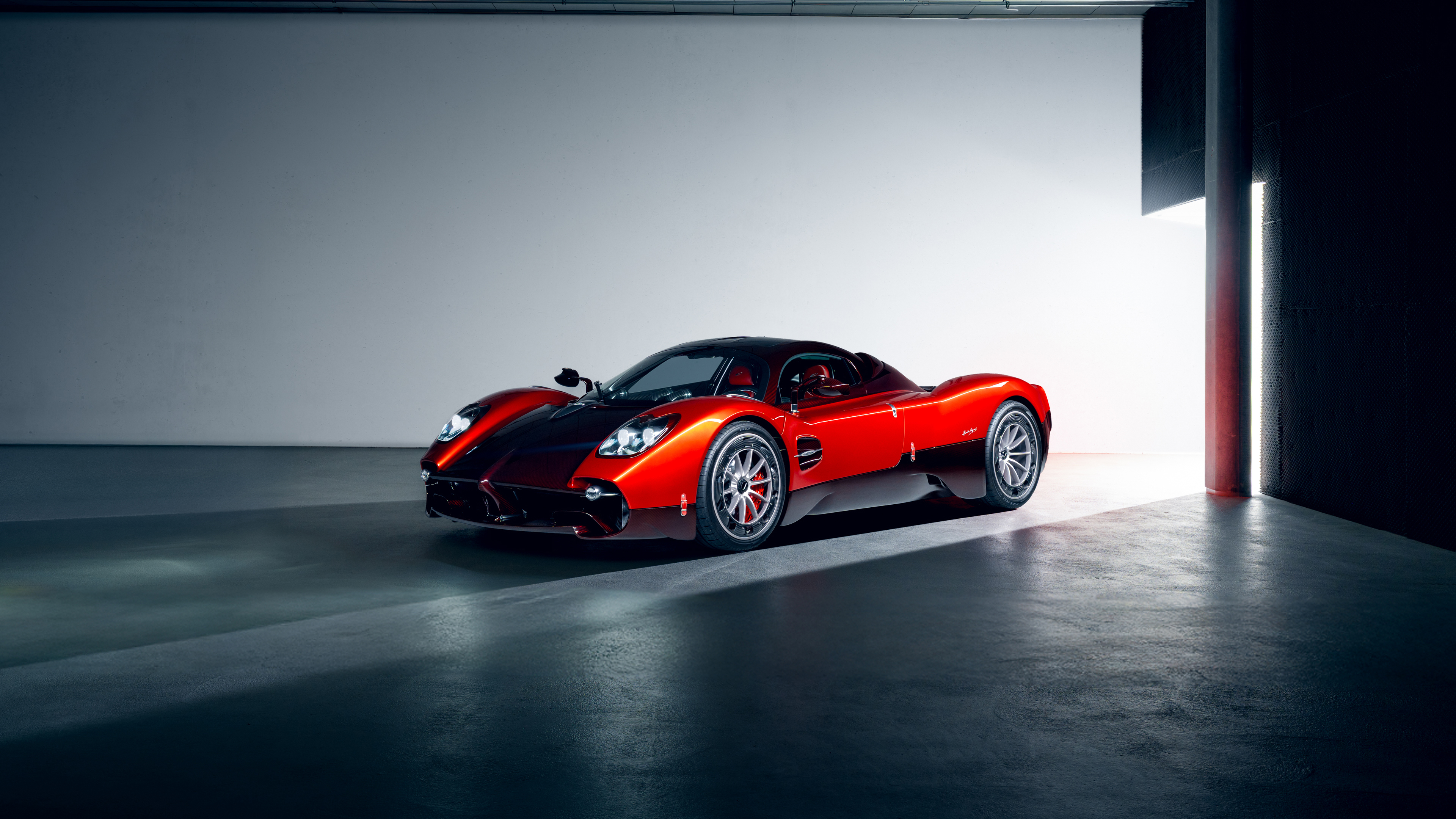 A stunning close-up of a vibrant red Pagani Utopia hypercar, highlighting its aerodynamic curves and sleek design.