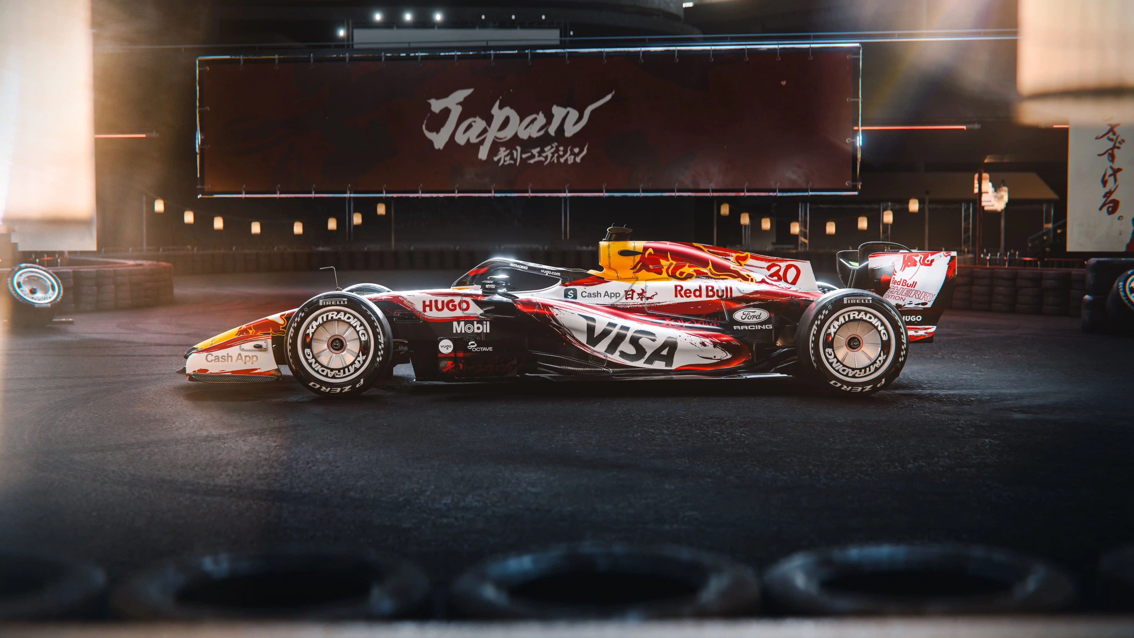 The VCARB 03 Formula One car racing through a turn at the Japanese Grand Prix.