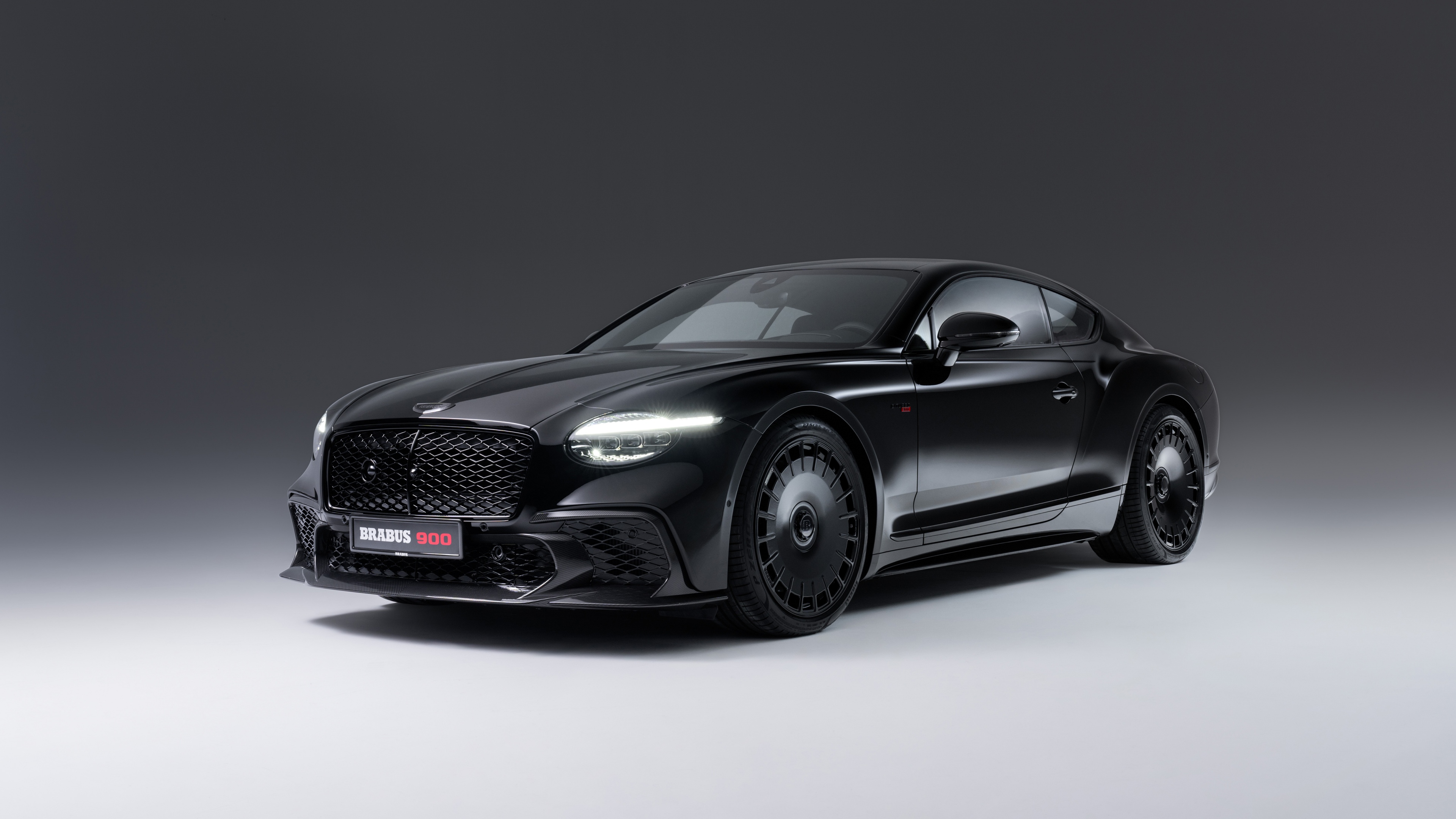 A sleek and polished 2025 Brabus 900 Superblack Bentley Continental GT Speed in a deep monochromatic black finish.