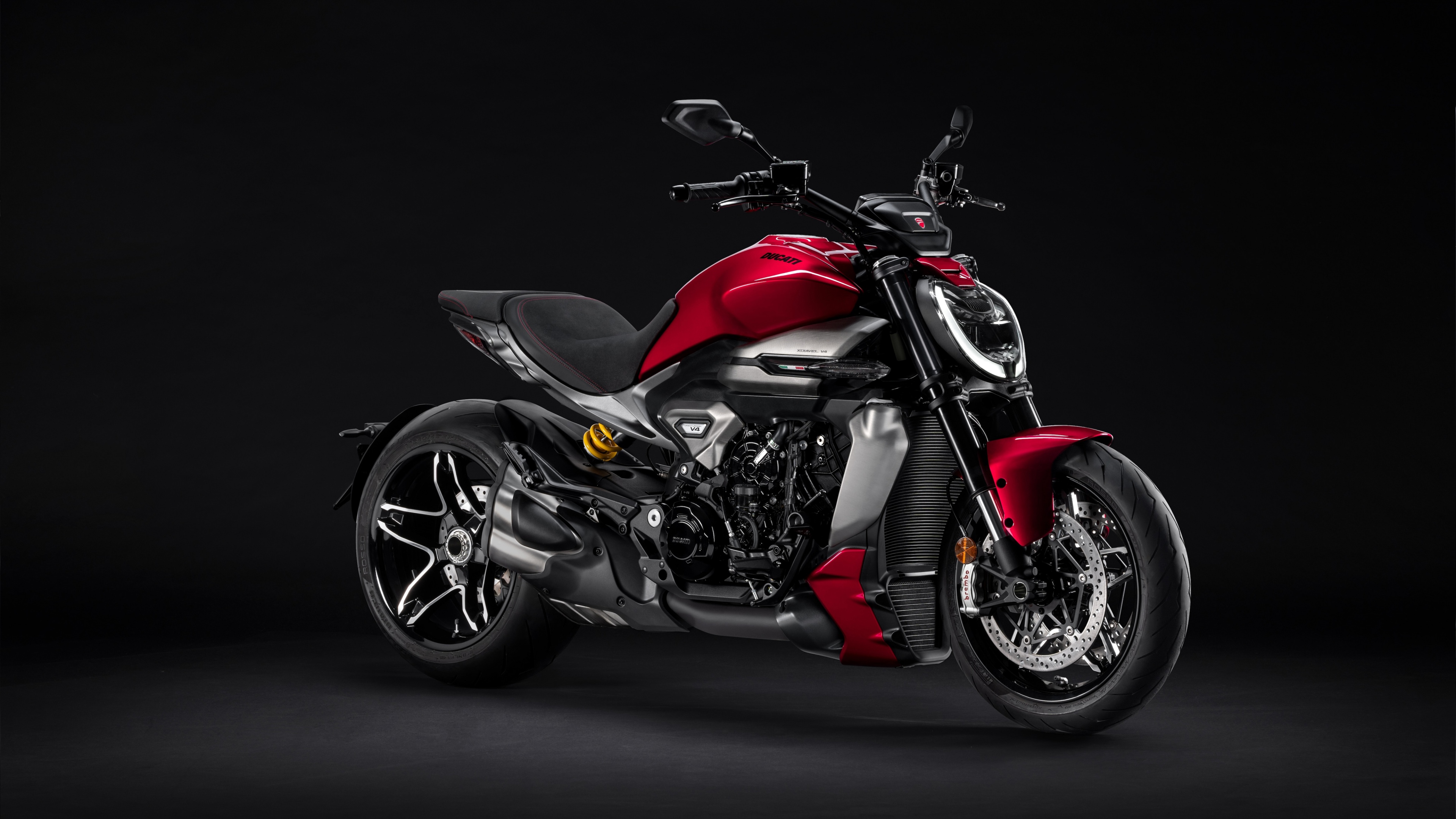 A high-resolution, close-up view of a 2025 Ducati XDiavel V4 motorcycle featuring a muscular design and dark aesthetic.