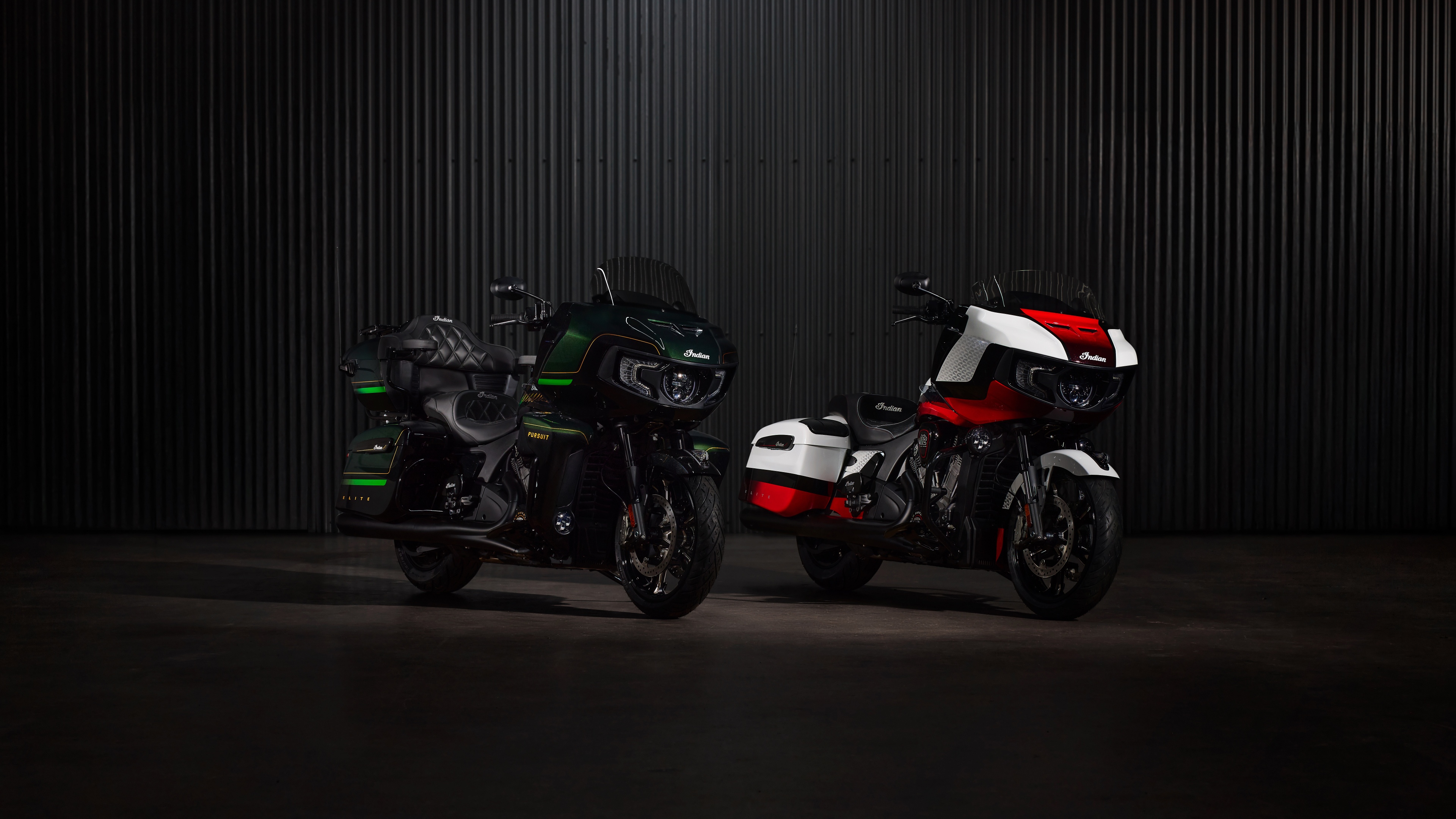 Detailed close-up of the 2025 Indian Chieftain Elite and Indian Pursuit Elite motorcycles in a dark, cinematic setting.