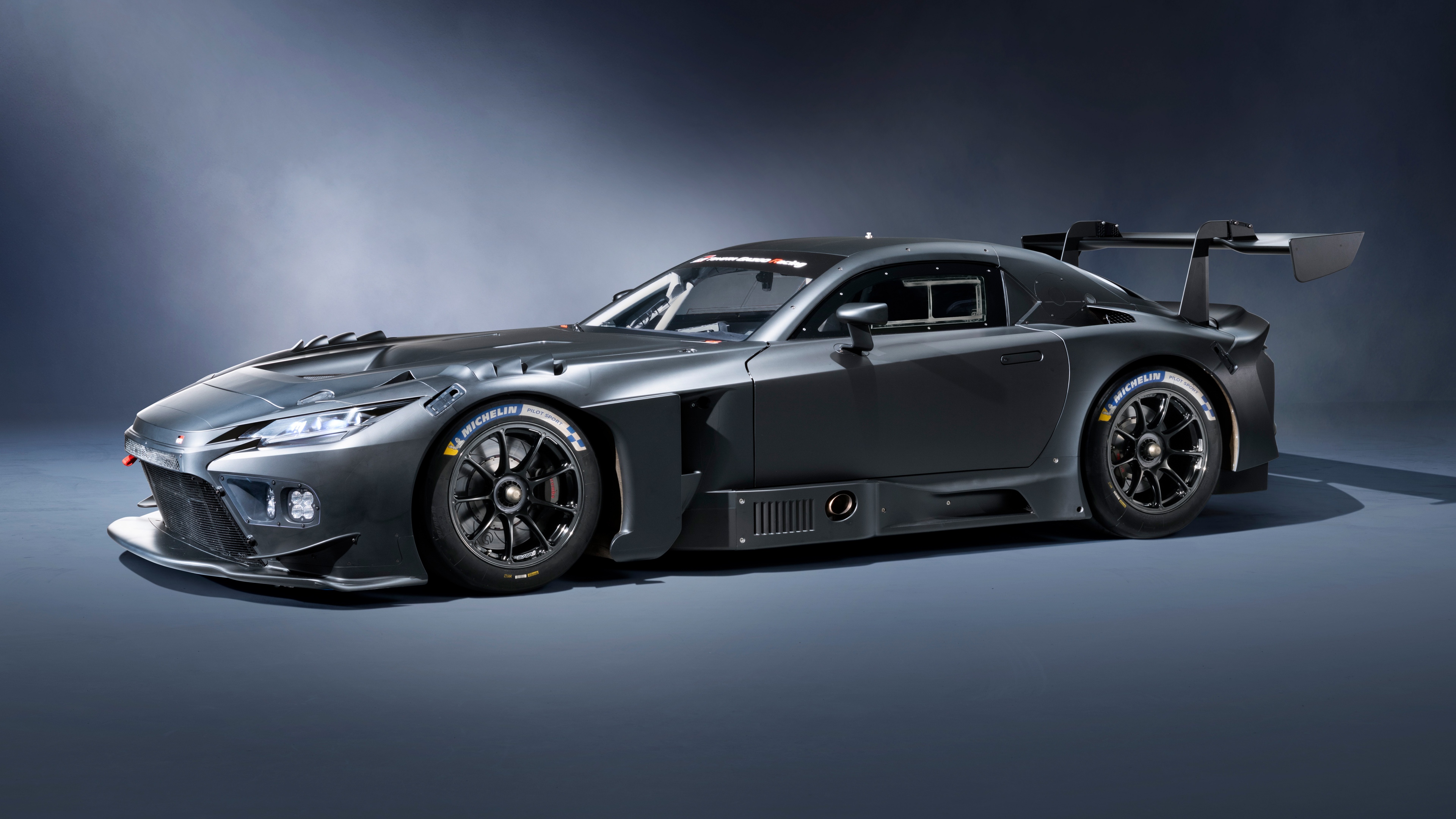 A sleek and aerodynamic 2025 Toyota GR GT3 Prototype racing car in a high-resolution studio setting.