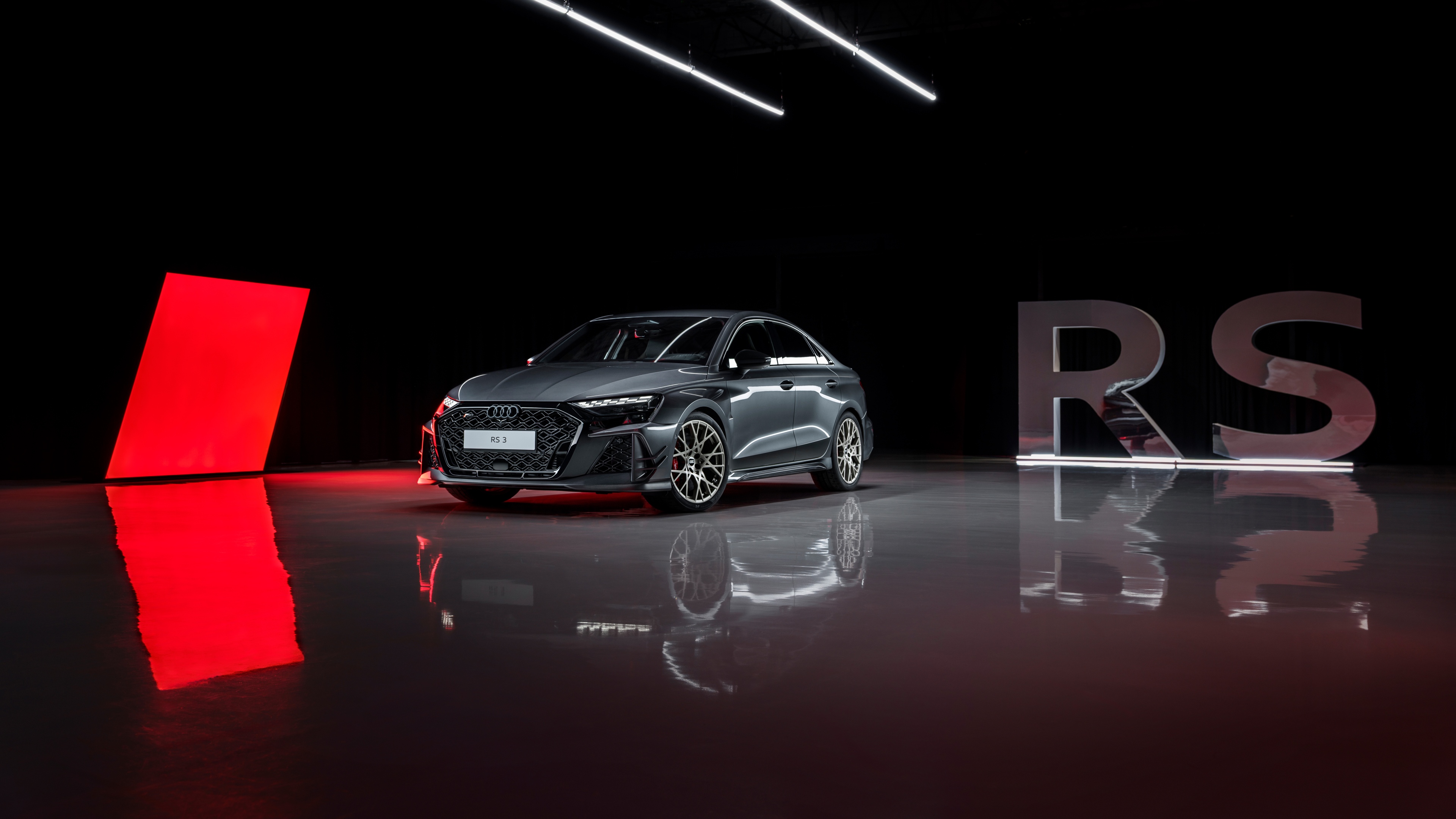 A highly detailed 2026 Audi RS 3 Sedan presented in a moody, dark studio setting.