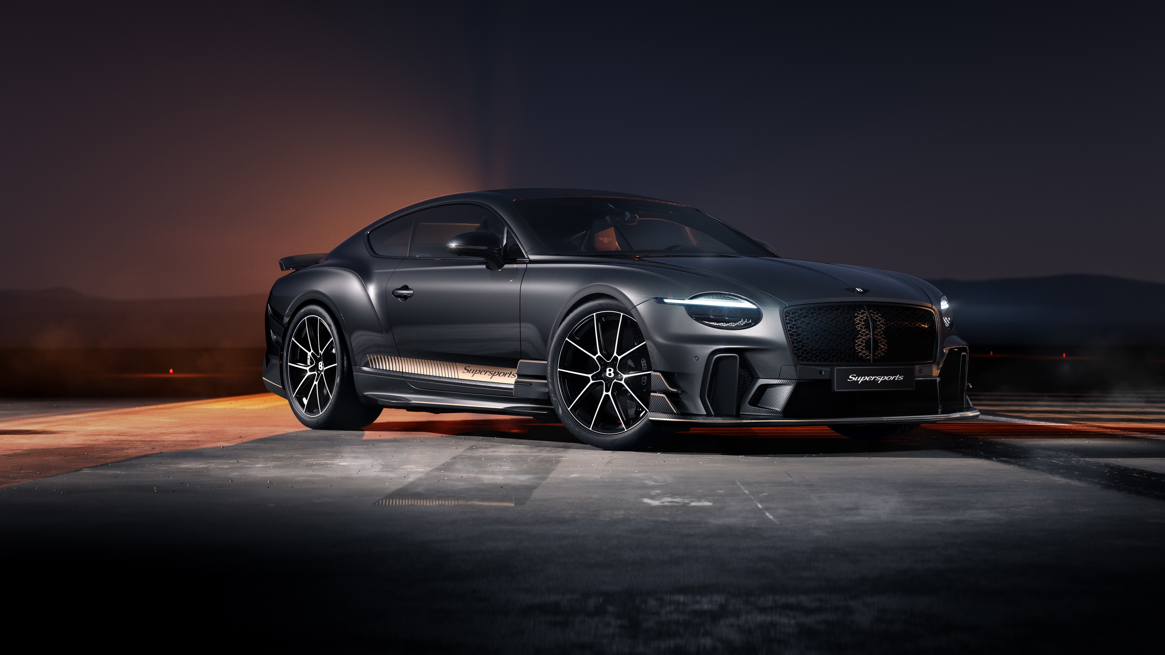 A high-resolution, cinematic view of a 2026 Bentley Continental GT Supersports parked in a dark, atmospheric night setting.