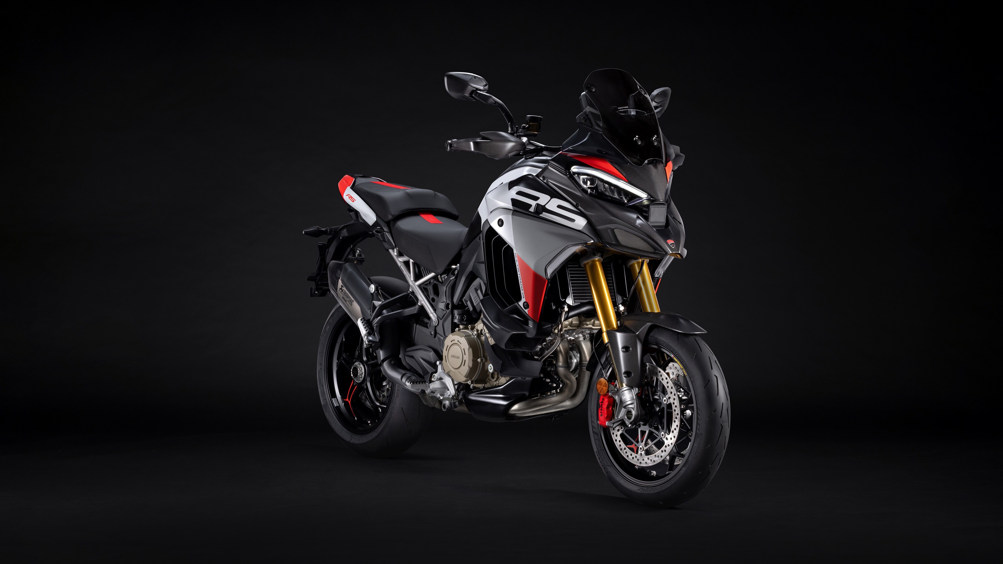 A sleek 2026 Ducati Multistrada V4 RS adventure motorcycle featured against a dark, minimalist background.