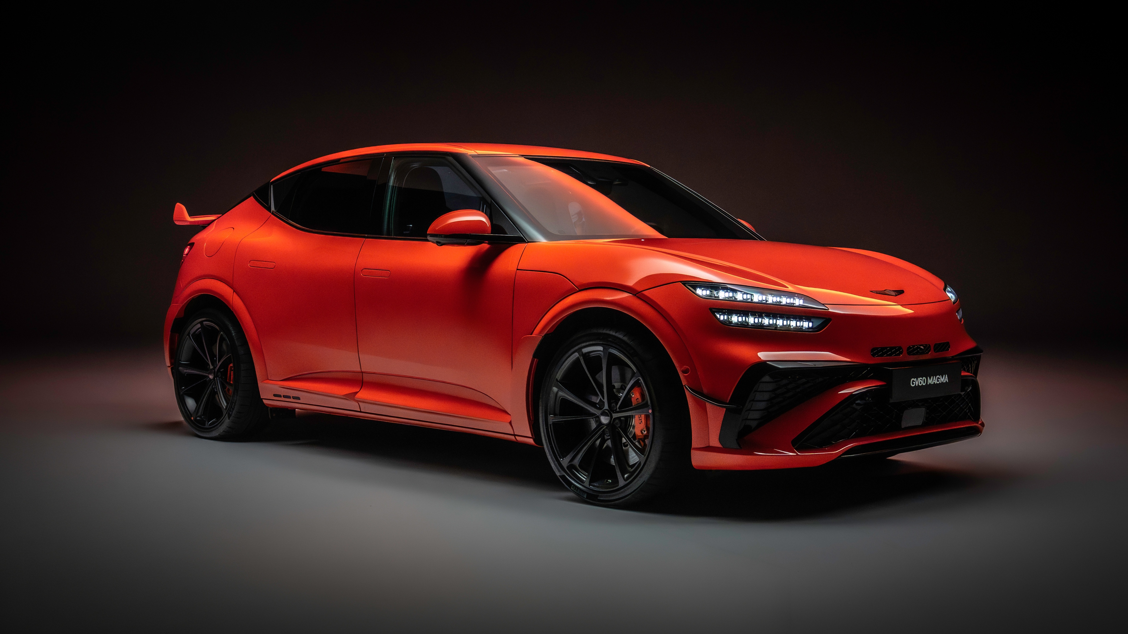 A futuristic 2026 Genesis GV60 Magma electric crossover featuring a sleek aerodynamic body and high-performance design.