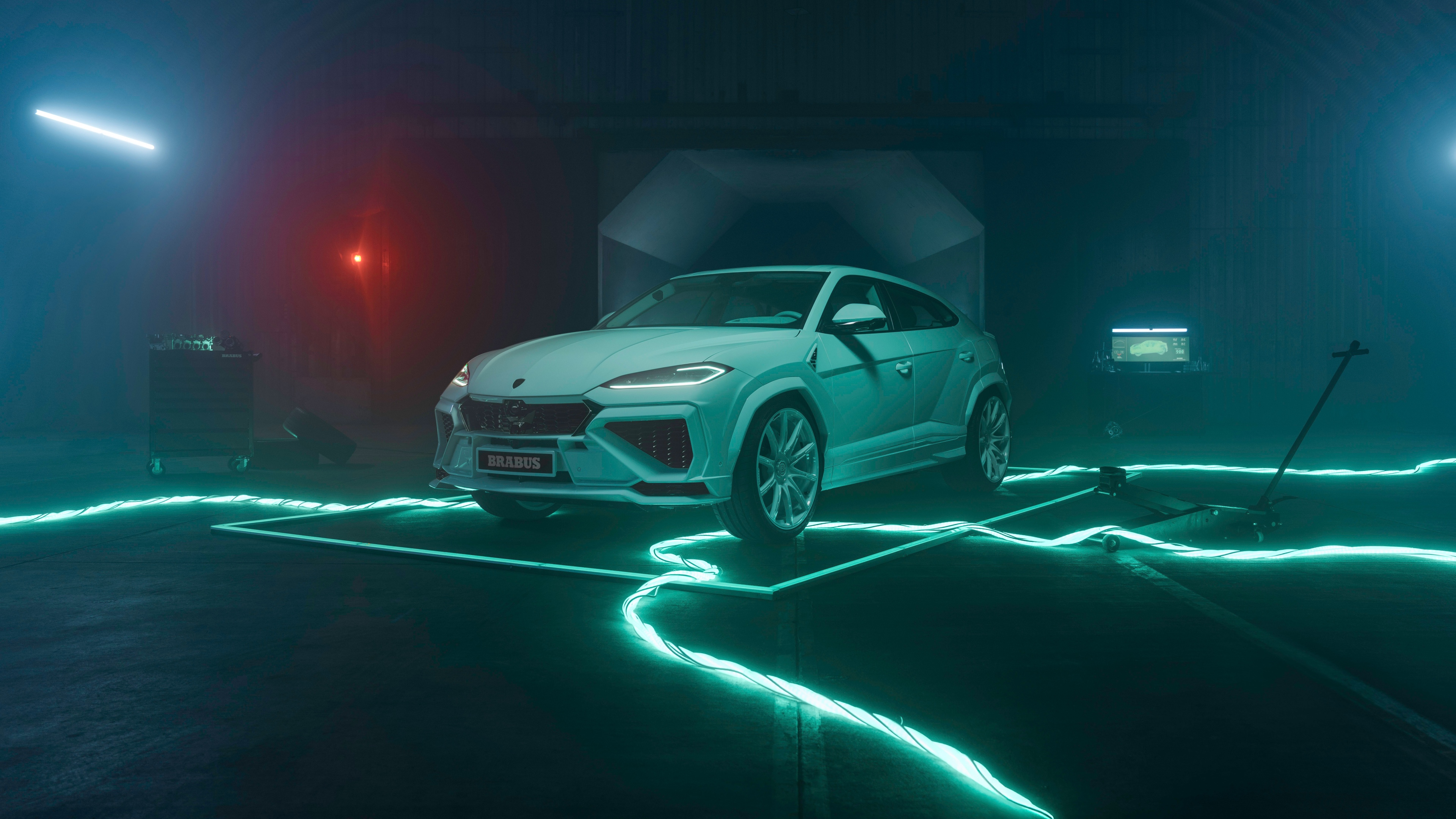 A high-resolution view of the 2026 Lamborghini Urus SE featuring vibrant neon light accents against a dark, cinematic background.