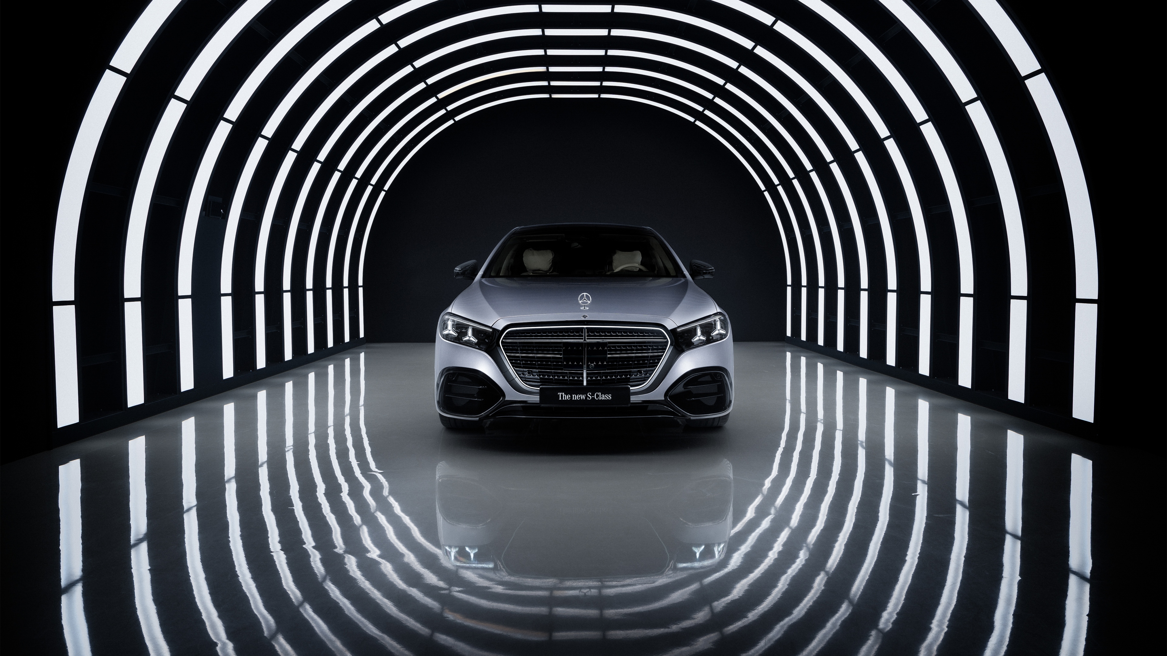 2026 Mercedes-Benz S 580 e 4MATIC luxury sedan with prominent LED lighting against a dark background
