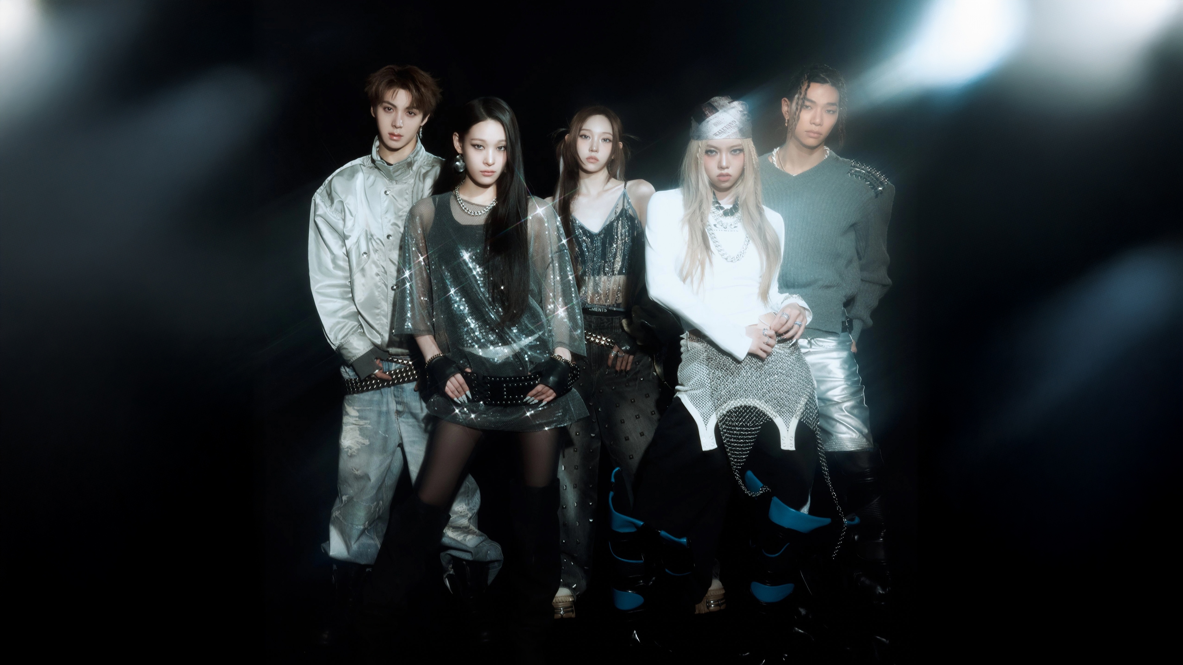 A professional group portrait of K-Pop members Youngseo, Annie, Bailey, Tarzzan, and Woochan from ALLDAY PROJECT against a dark, moody background.