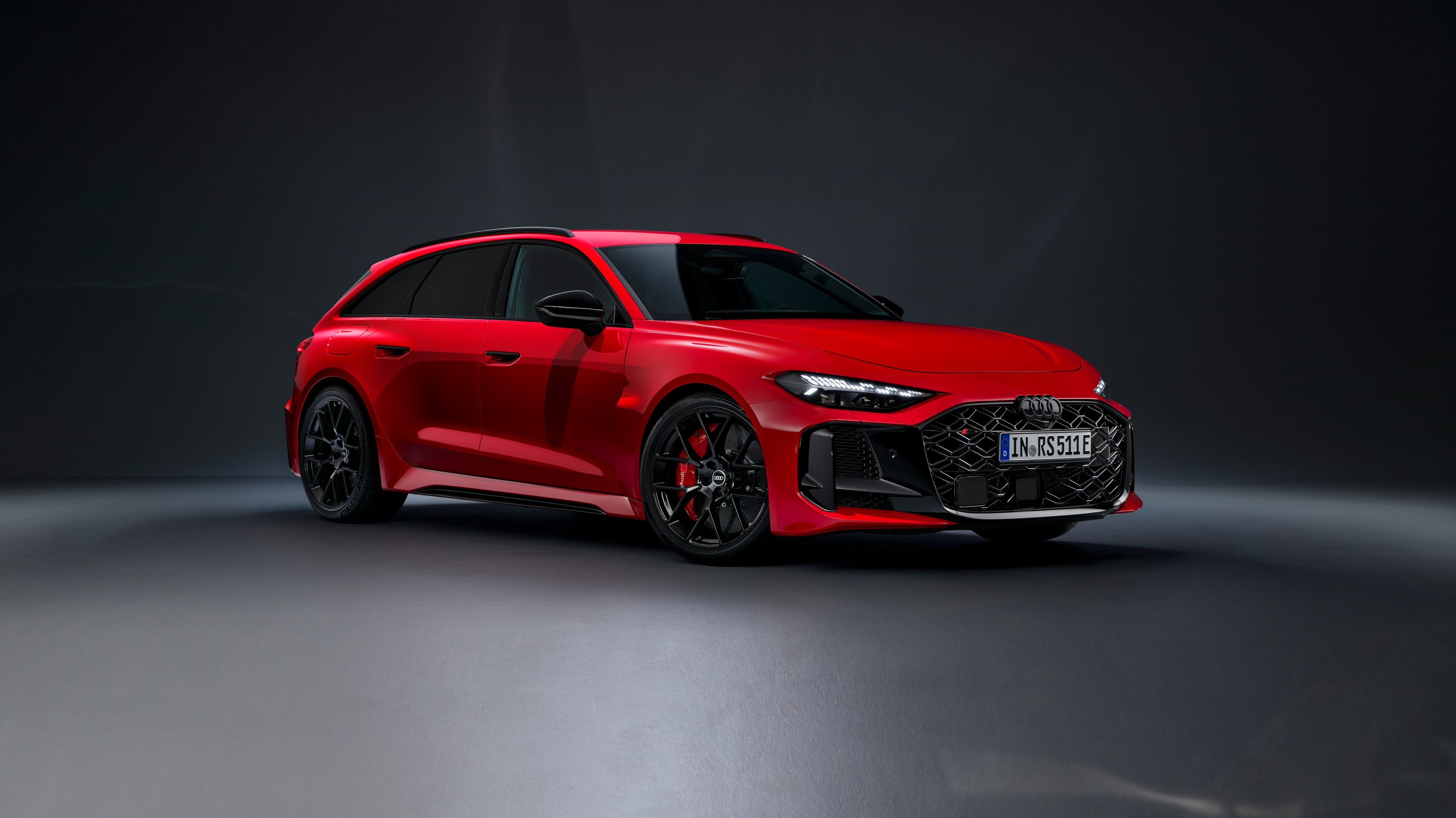 A group of bright red, high-performance cars driving through a futuristic urban environment, captured in 5K resolution.