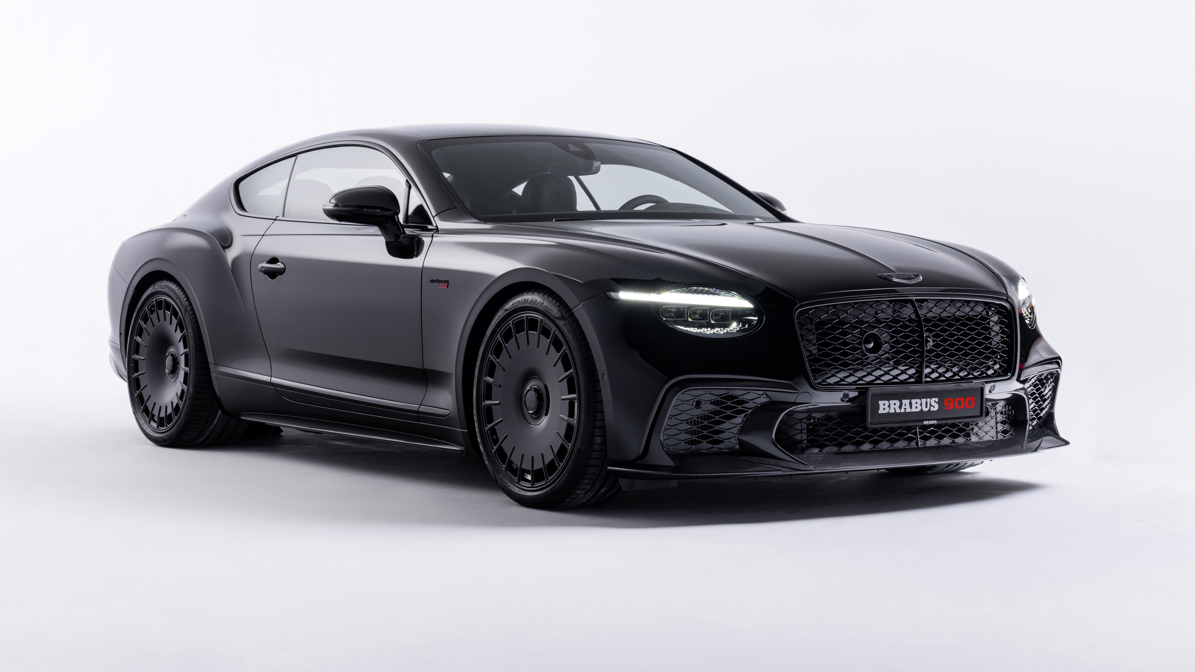 A high-resolution 5K image of a black Brabus Bentley Continental GT Speed against a clean white background.