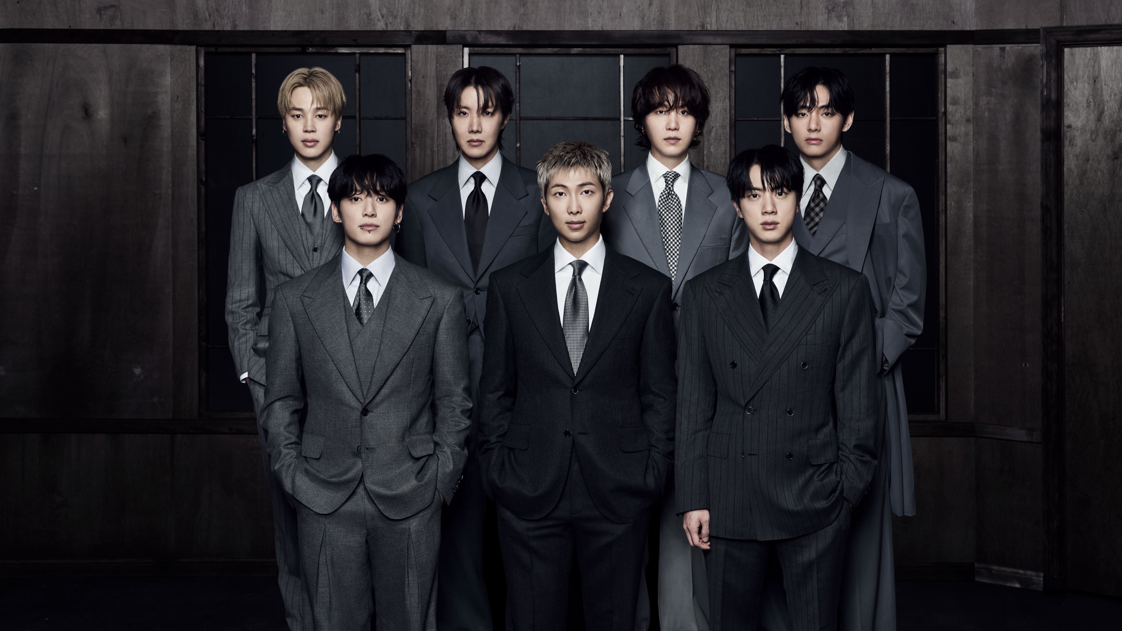 A high-resolution cinematic depiction of the K-pop group BTS in a futuristic 2026 setting.