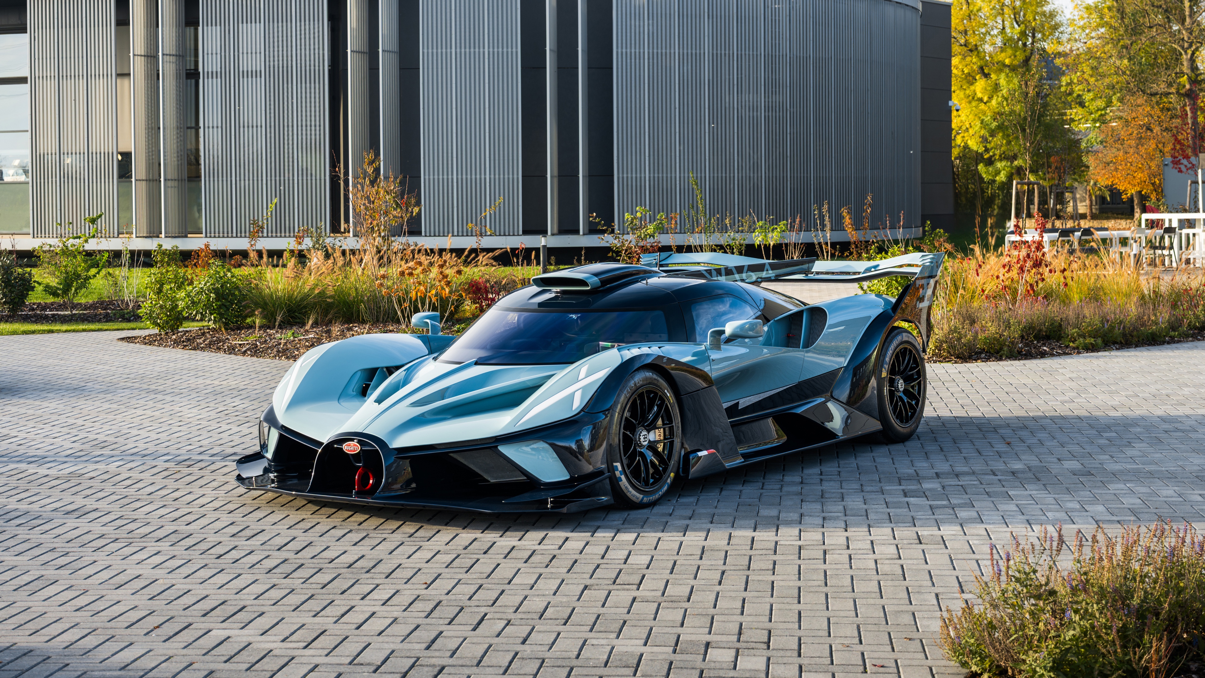 A high-performance Bugatti Bolide hypercar positioned outdoors, emphasizing its aerodynamic track-ready design.