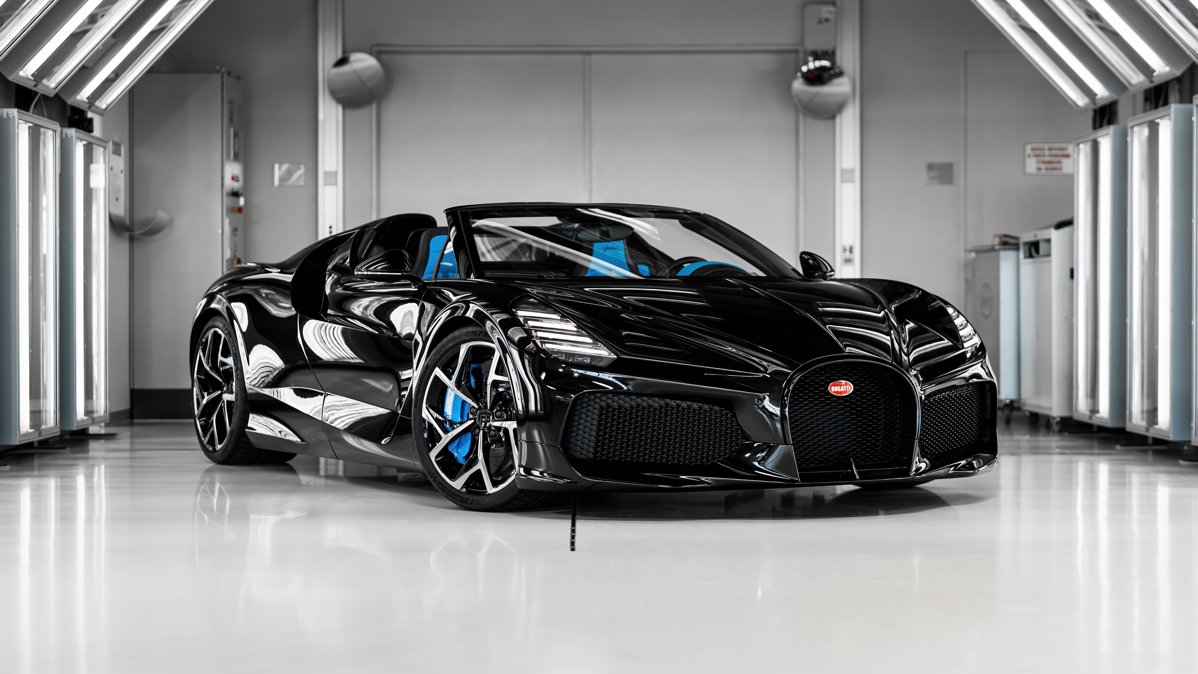 A sleek and powerful black Bugatti W16 Mistral hypercar roadster.