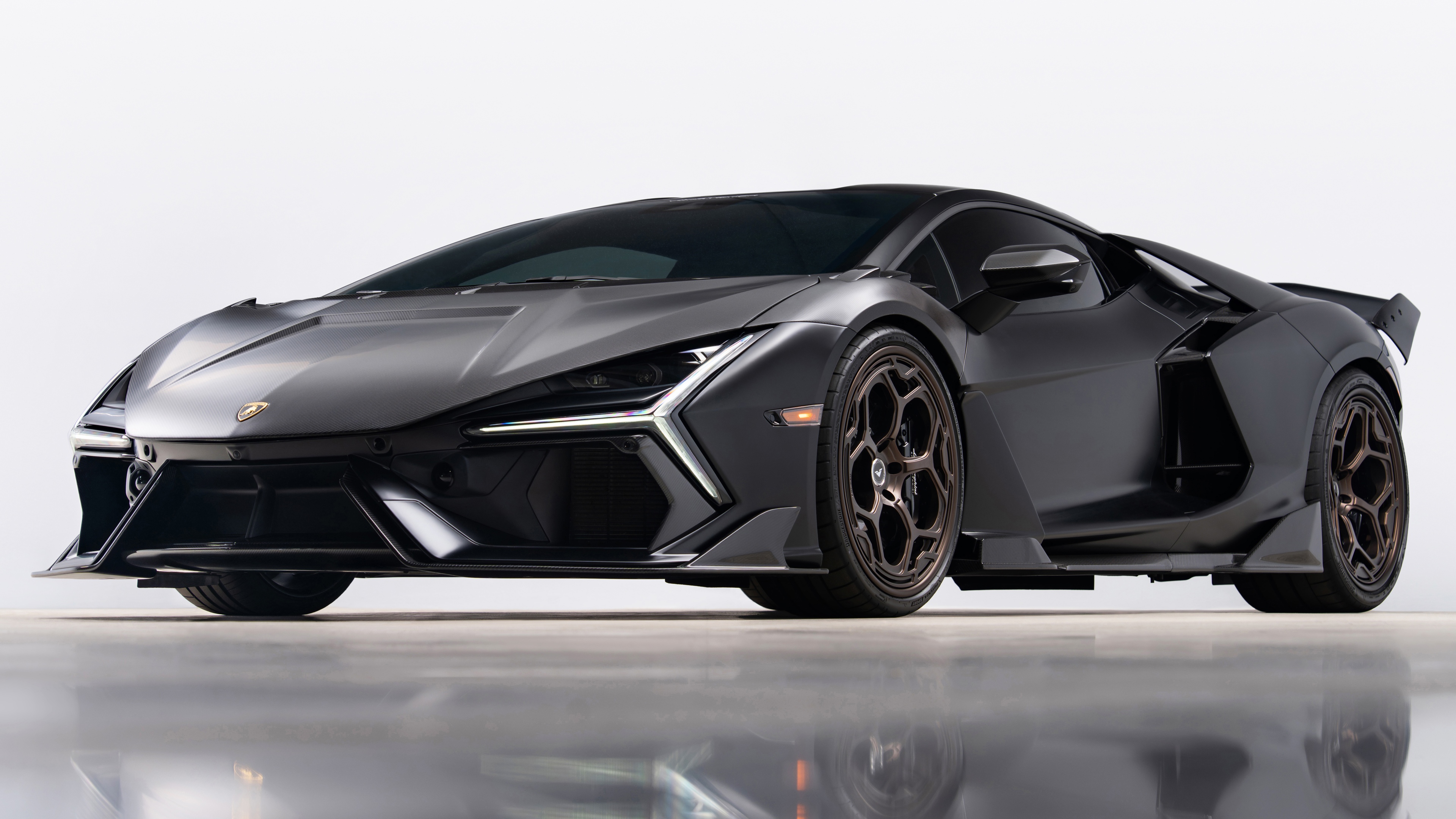 A close-up, high-detail view of a Lamborghini Revuelto featuring a premium carbon fiber exterior texture.