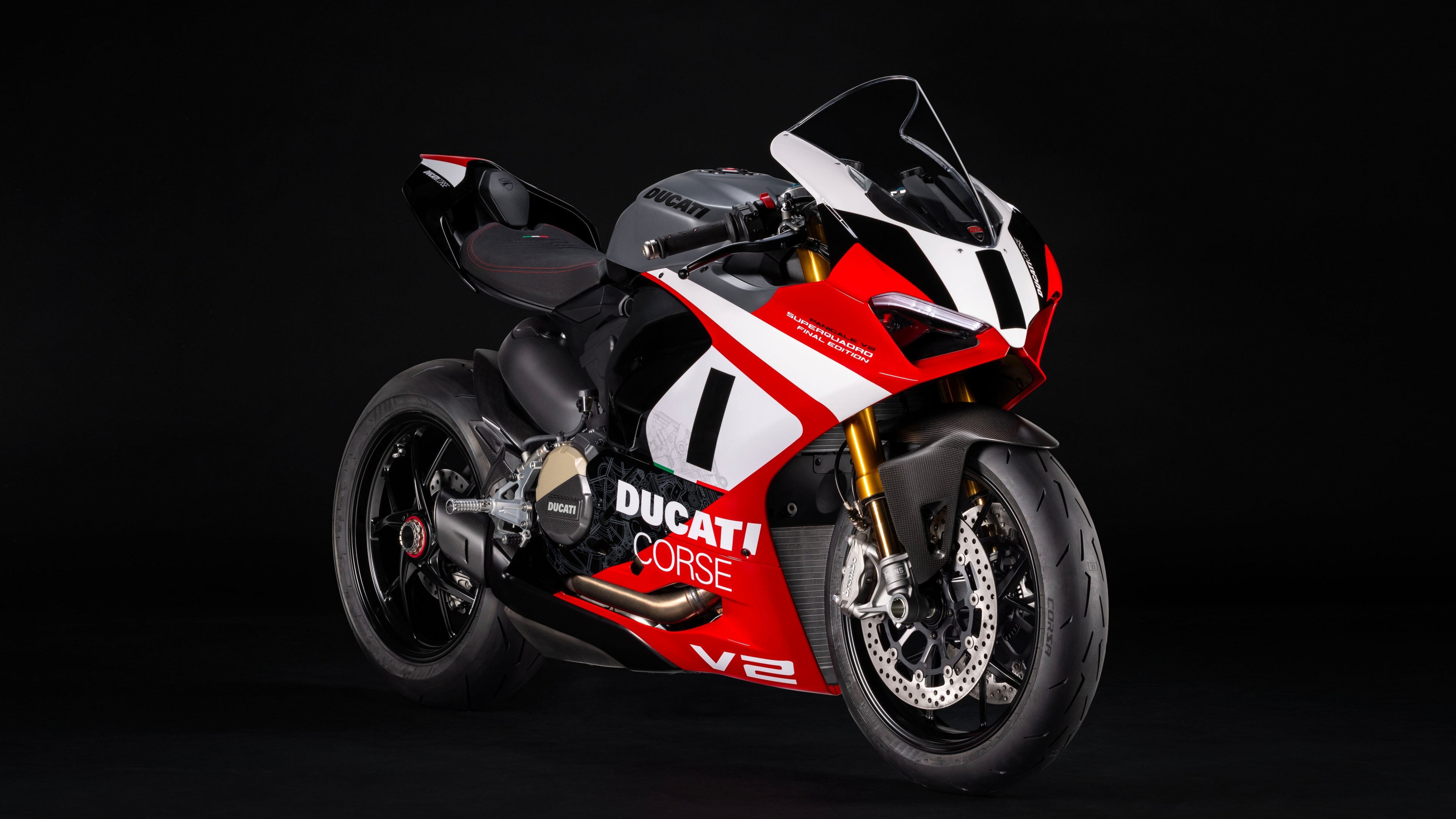 A cinematic, high-detail view of a Ducati Panigale V2 motorcycle against a dark, moody background.