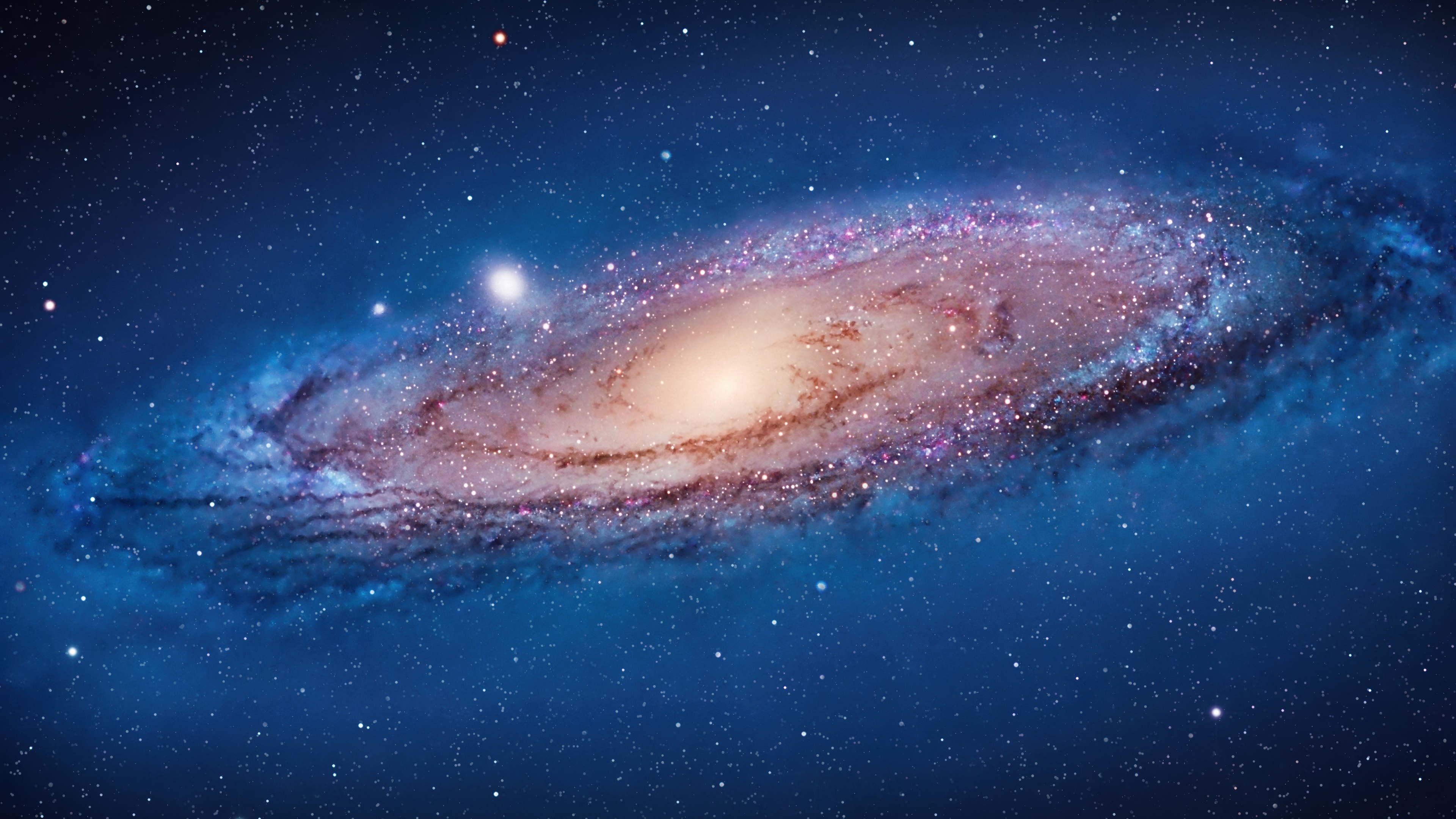A high-definition 5K wallpaper of a vibrant nebula and starfield in outer space.