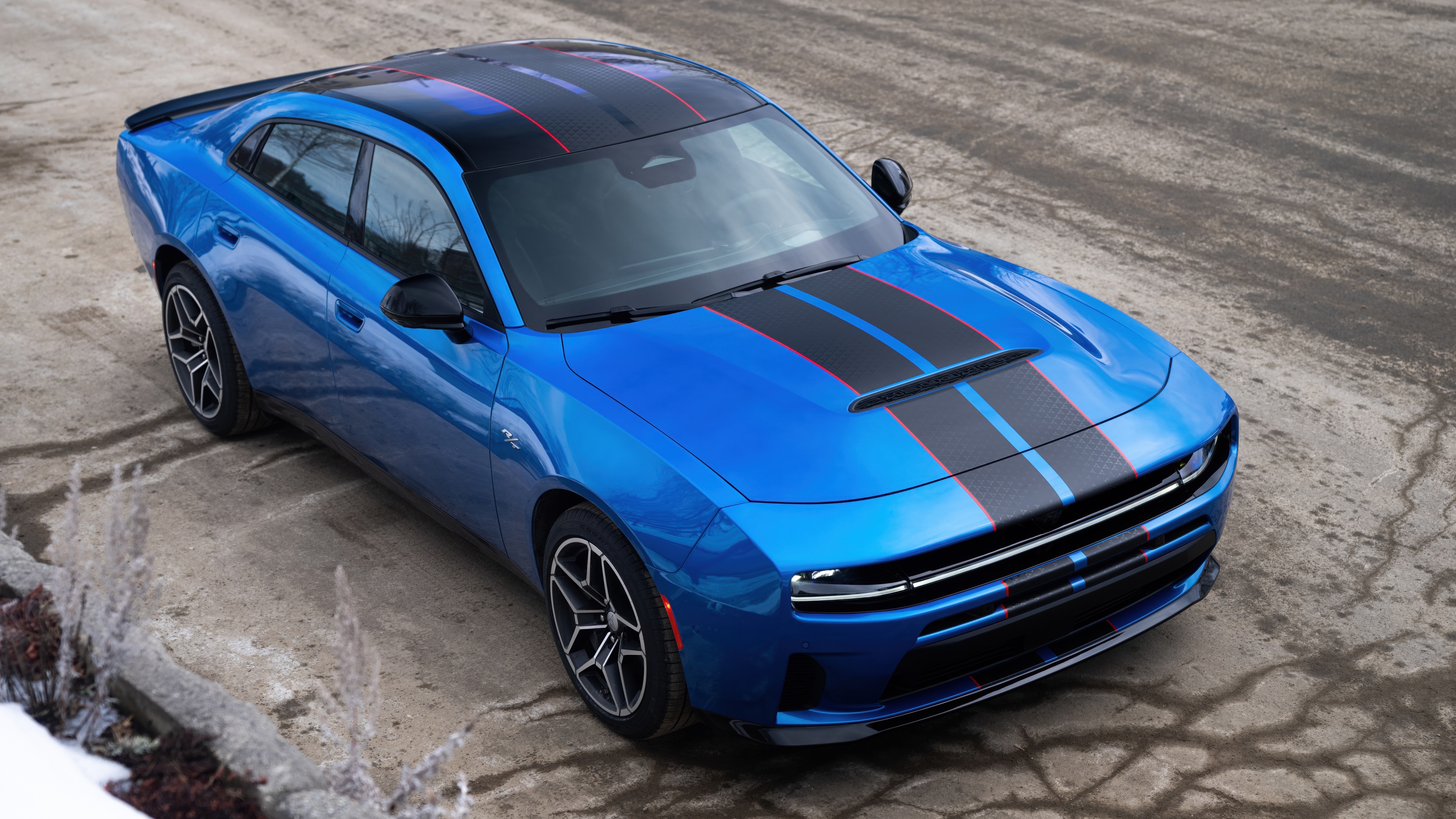 A sleek, metallic blue futuristic car with aerodynamic design and a modern aesthetic.