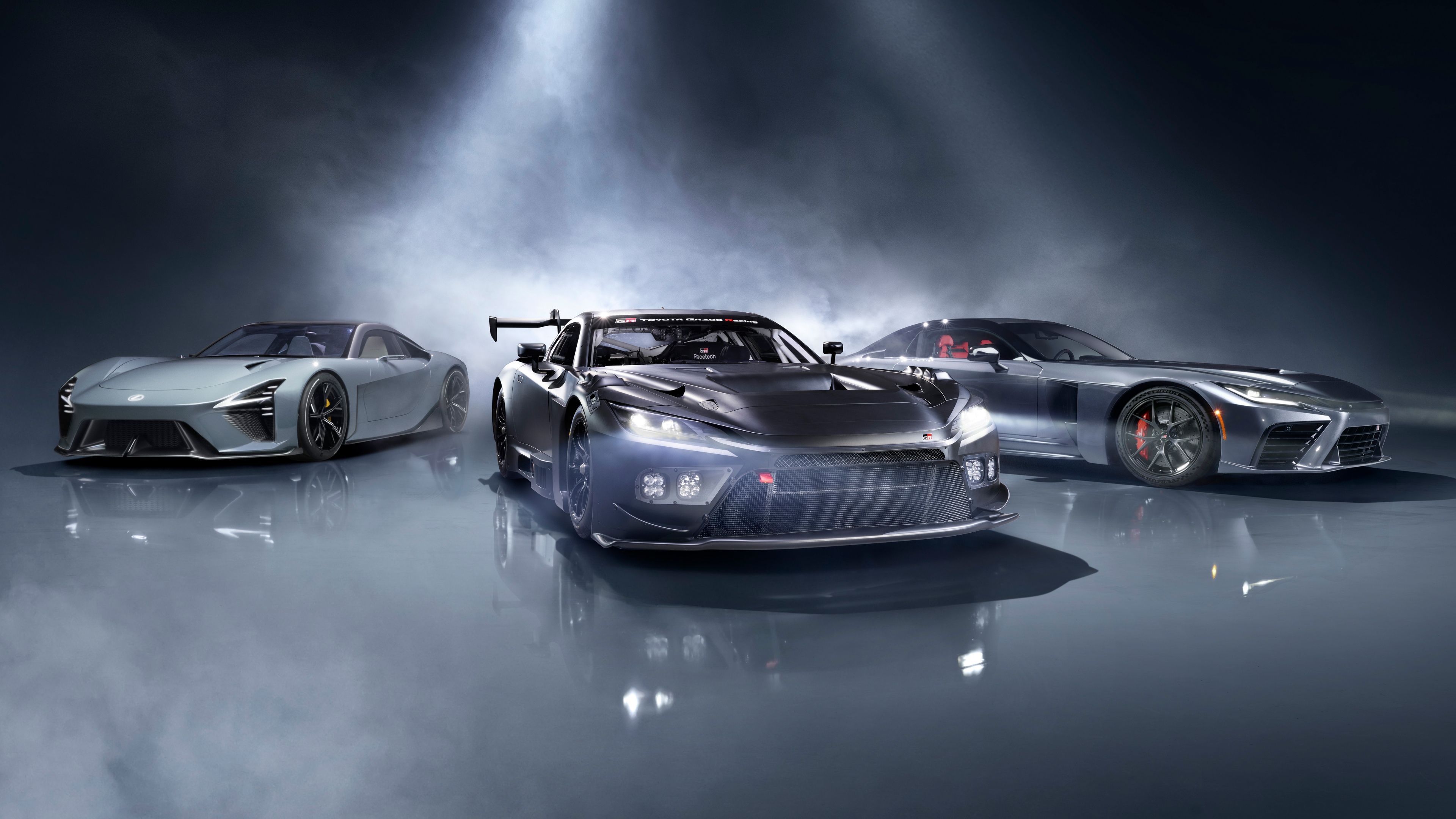 A lineup of futuristic electric sports cars featuring the Lexus LFA Concept and Toyota GR GT prototypes with sleek aerodynamic bodies.