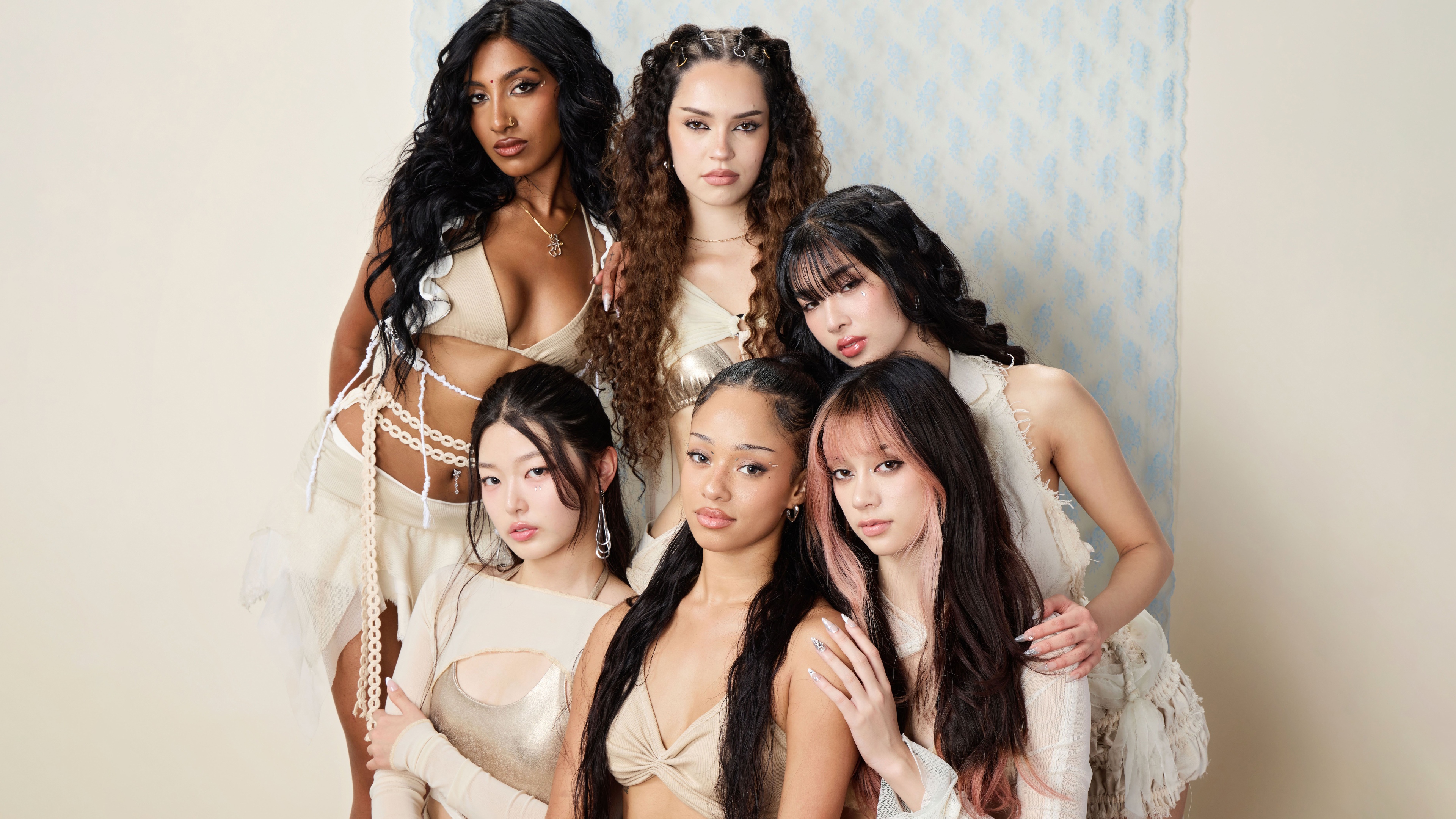 A high-resolution group photograph featuring the members of KATSEYE: Manon, Sophia, Daniela, Lara, Megan, and Yoonchae.